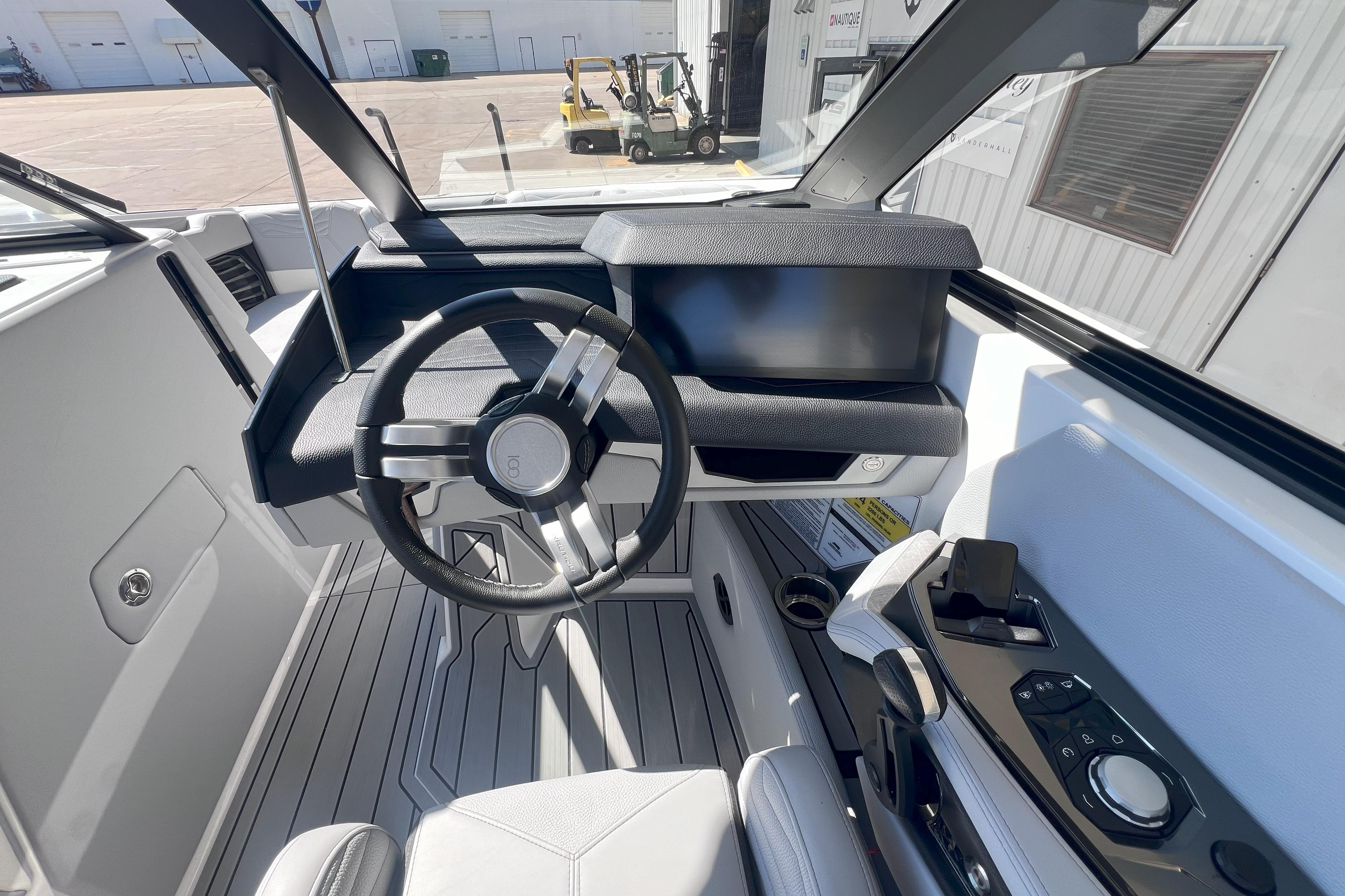 2025 Nautique Super Air Nautique G21 cockpit with modern steering and controls.