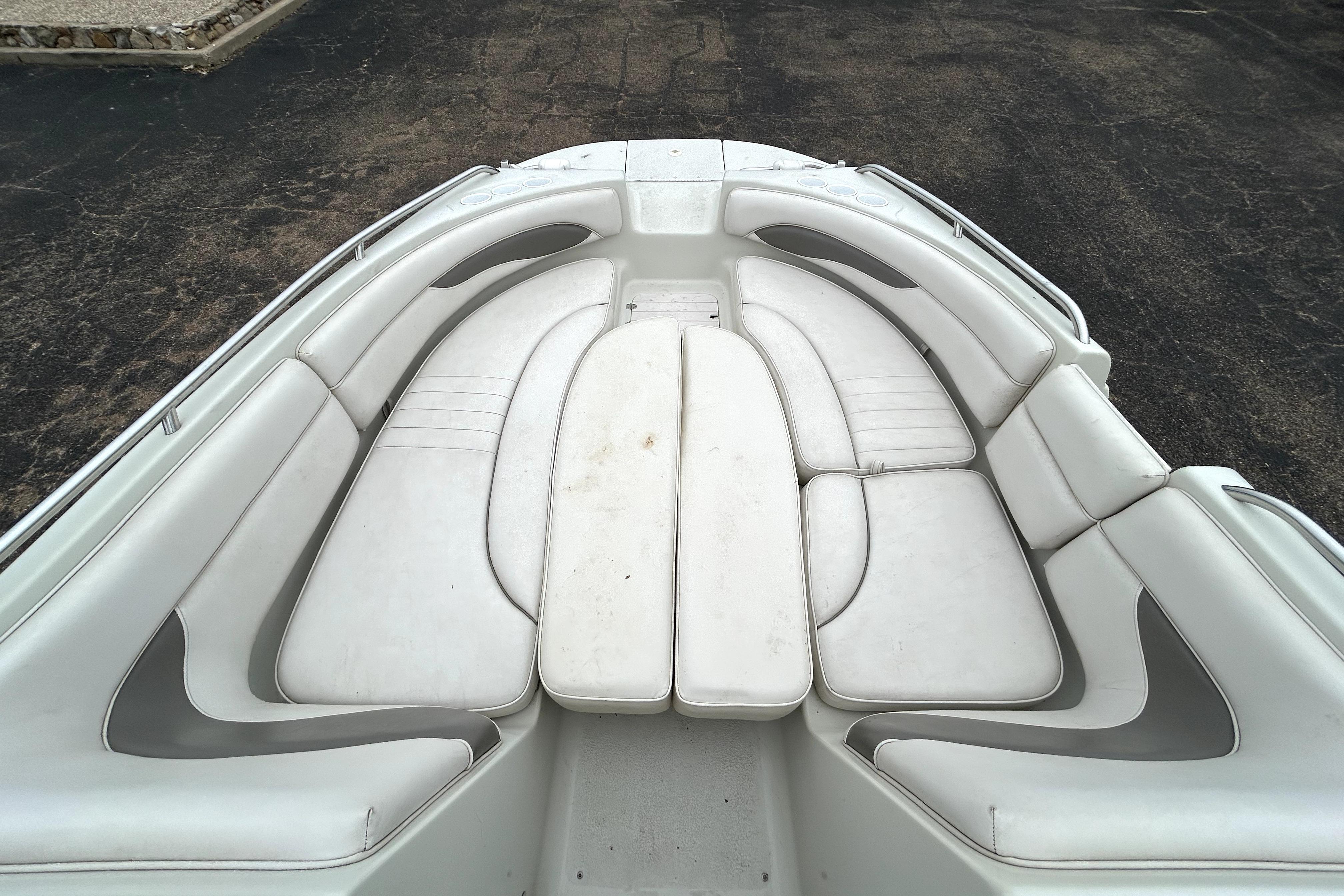2001 Crownline 239 DB boat interior with white cushioned seating arrangement.