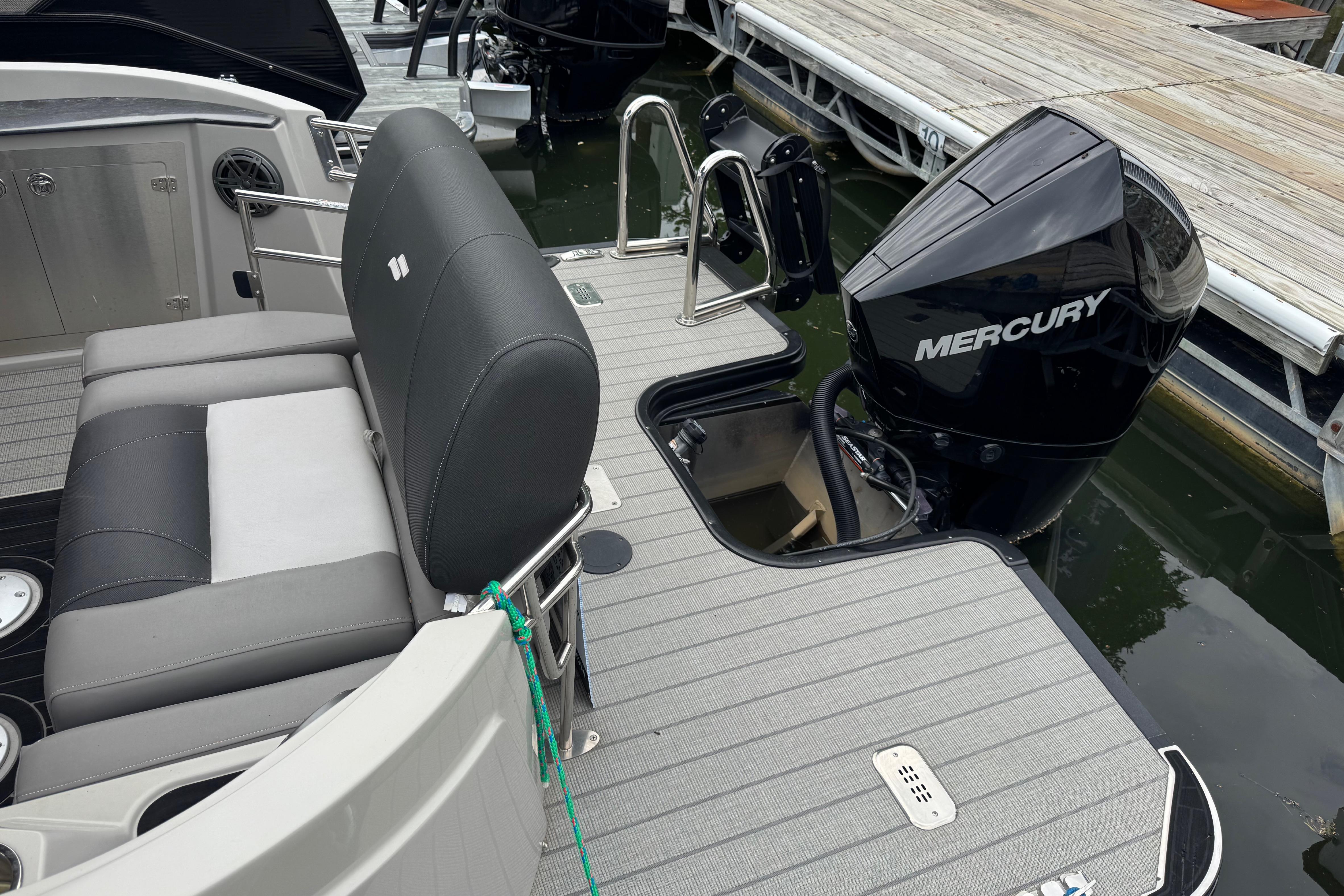 2023 Starcraft MX 25 DL DH boat with Mercury outboard motor at dock.