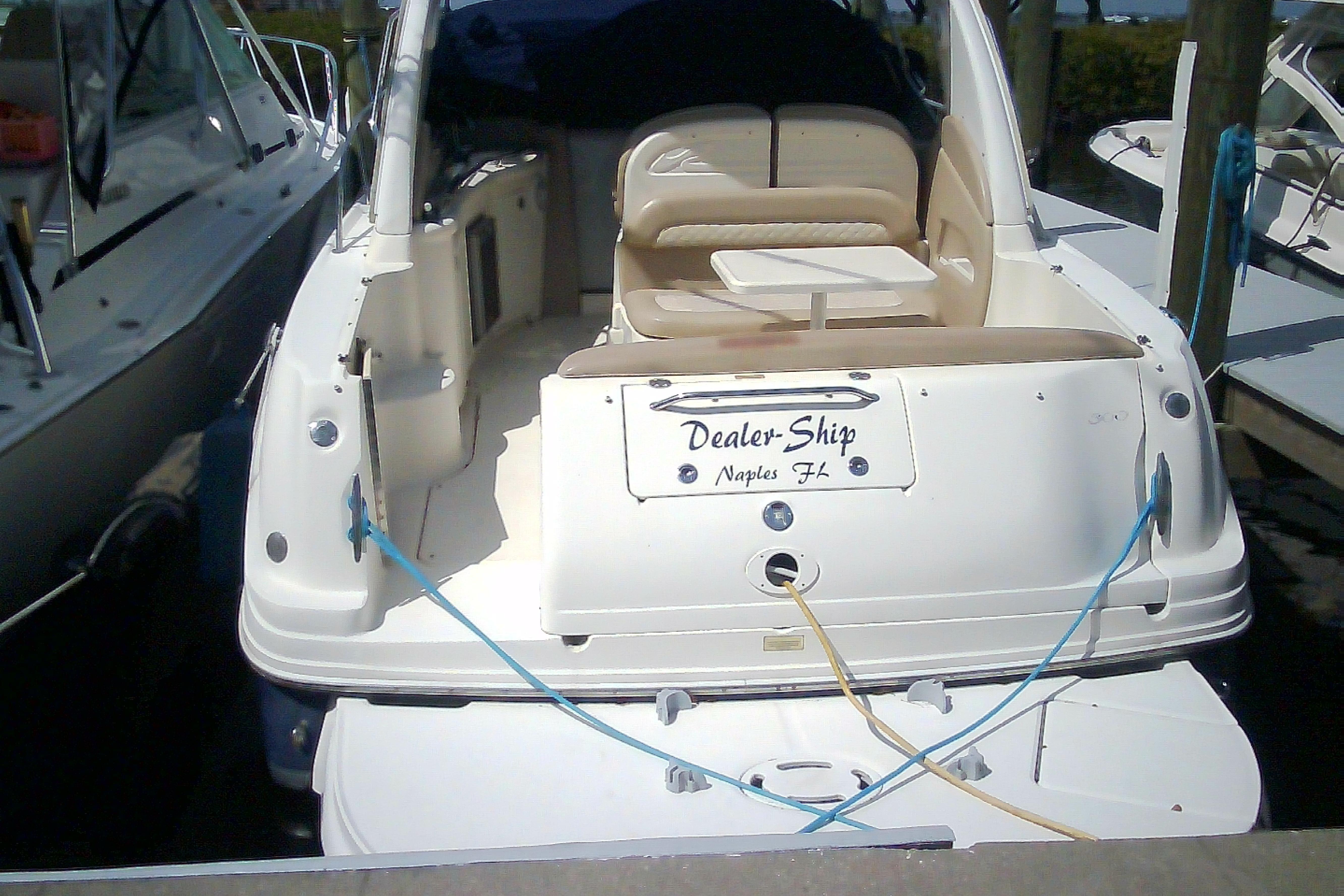 2005 Sea Ray 300 Sundancer docked, rear view with seating and table, Naples FL.