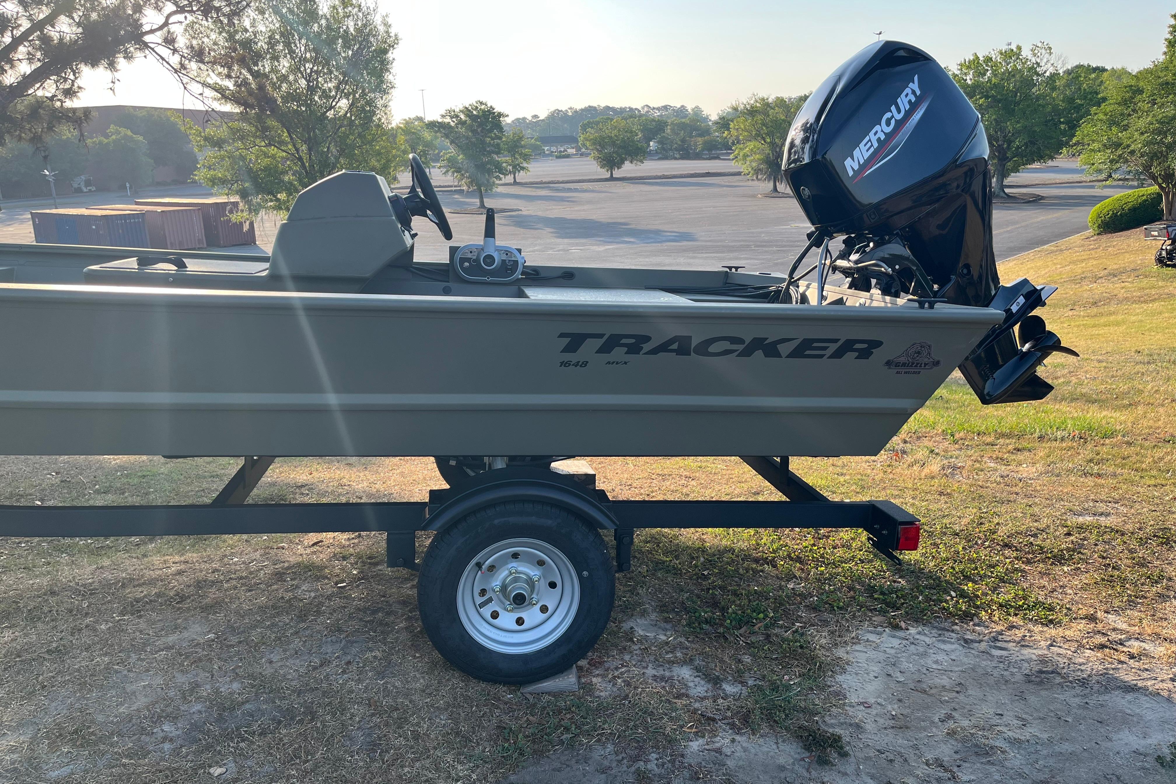 2026 Tracker Grizzly 1648 SC boat on trailer with Mercury outboard motor.
