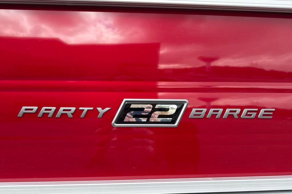 Sun Tracker Party Barge 22 RF DLX 2026 model emblem on red background.