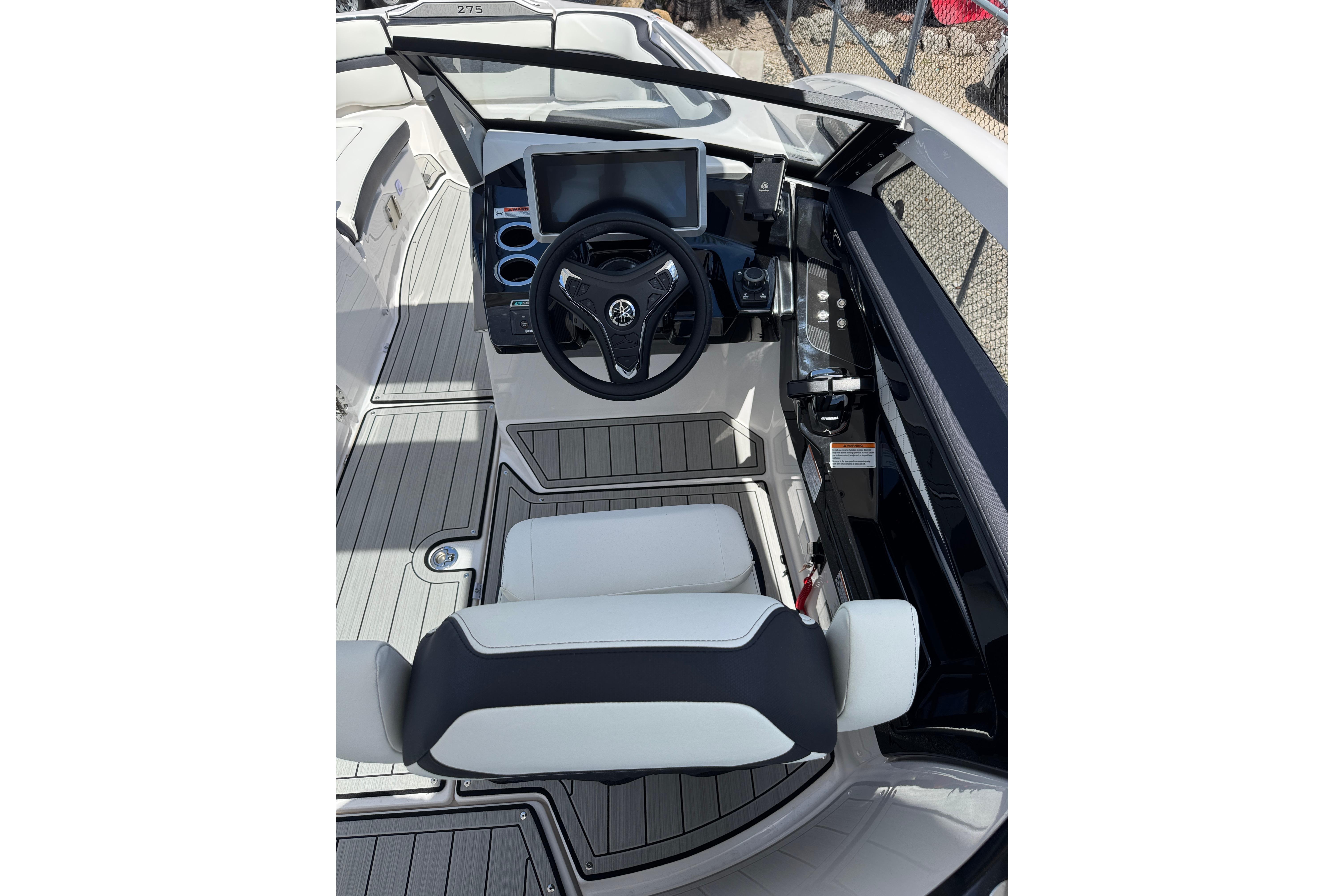 2026 Yamaha Boats 275SD cockpit with steering wheel and modern controls.