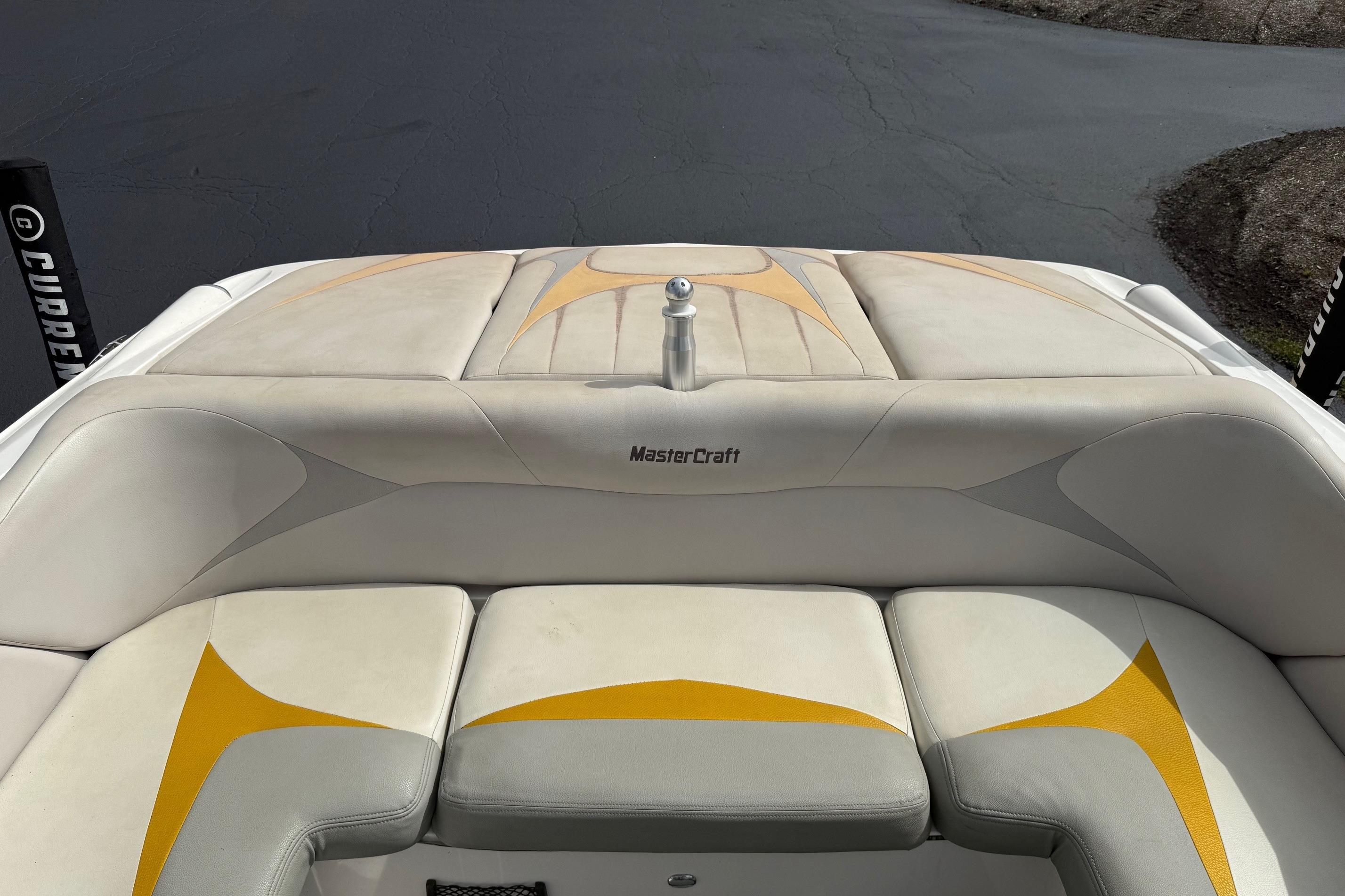 2008 MasterCraft X-15 boat interior with beige and yellow upholstery.