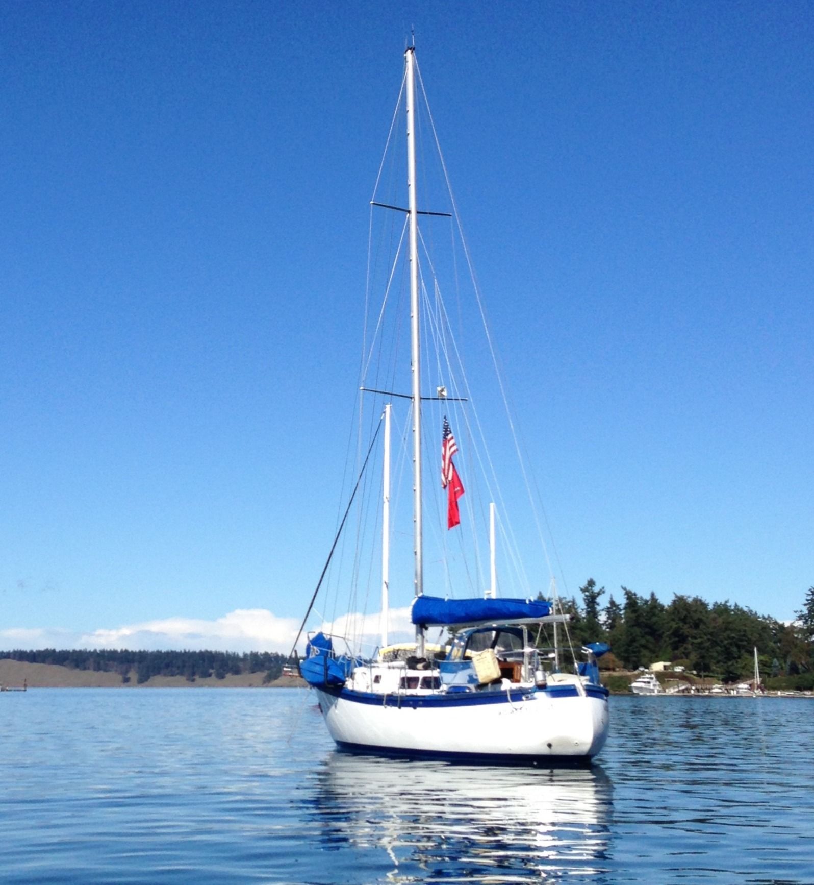 Custom 341 sailboat from 1994 on calm water under blue sky.