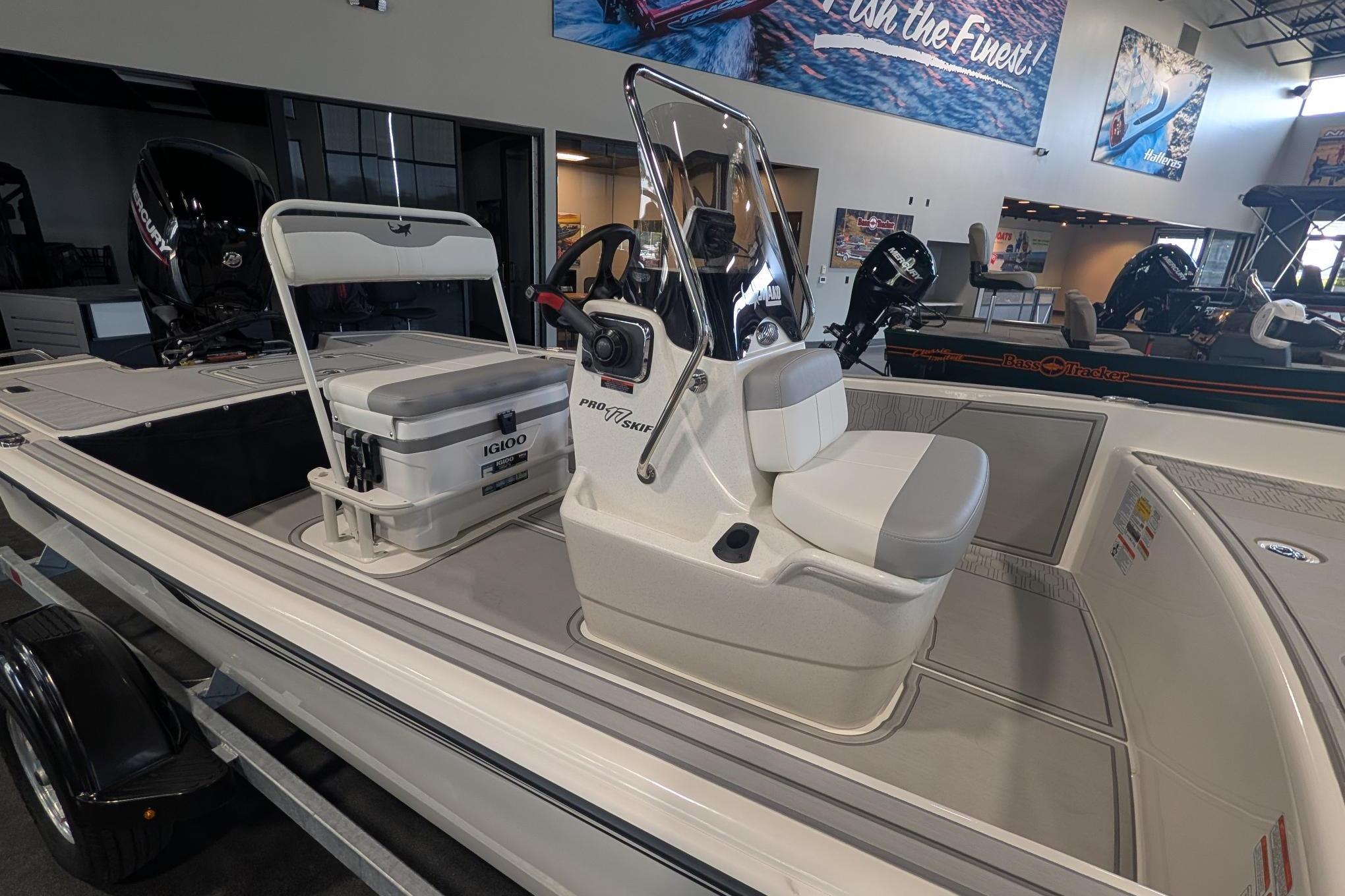 2026 Mako Pro Skiff 17 CC boat interior with console and seating in showroom.