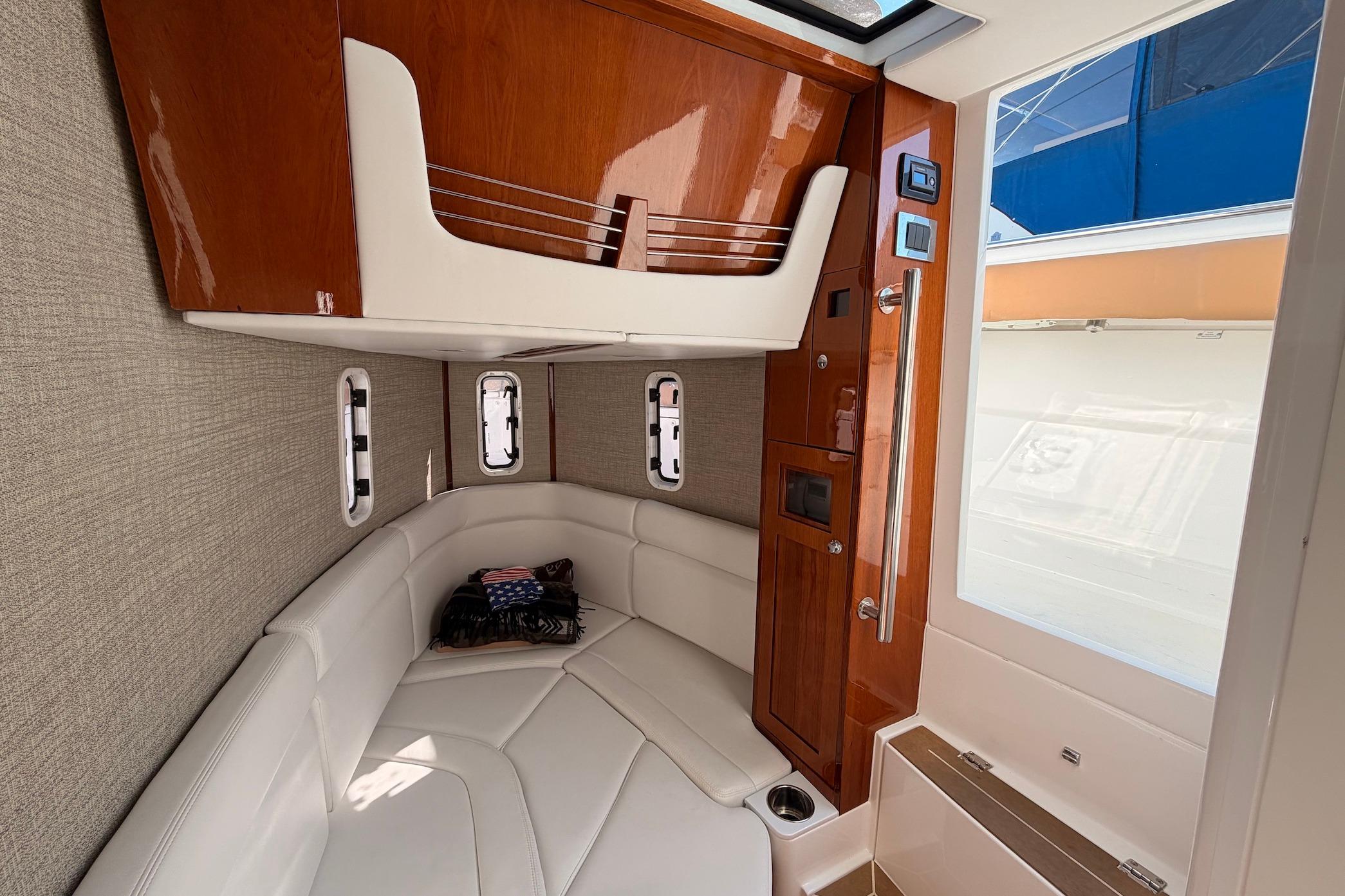 Luxurious interior of 2022 HCB 42 Lujo boat with elegant wood and leather finishes.