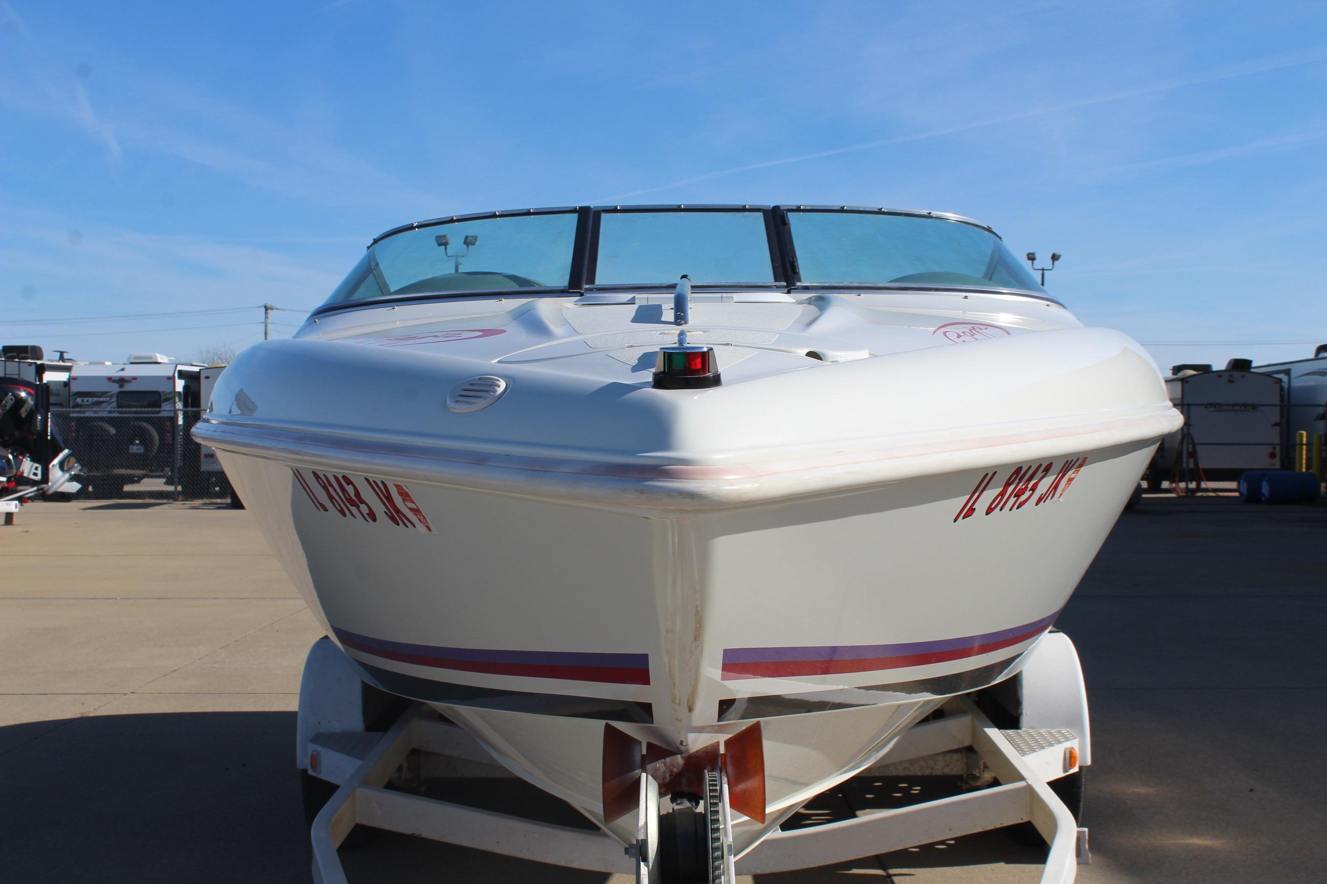 1996 Baja 232 speedboat on trailer, front view, clear sky background.