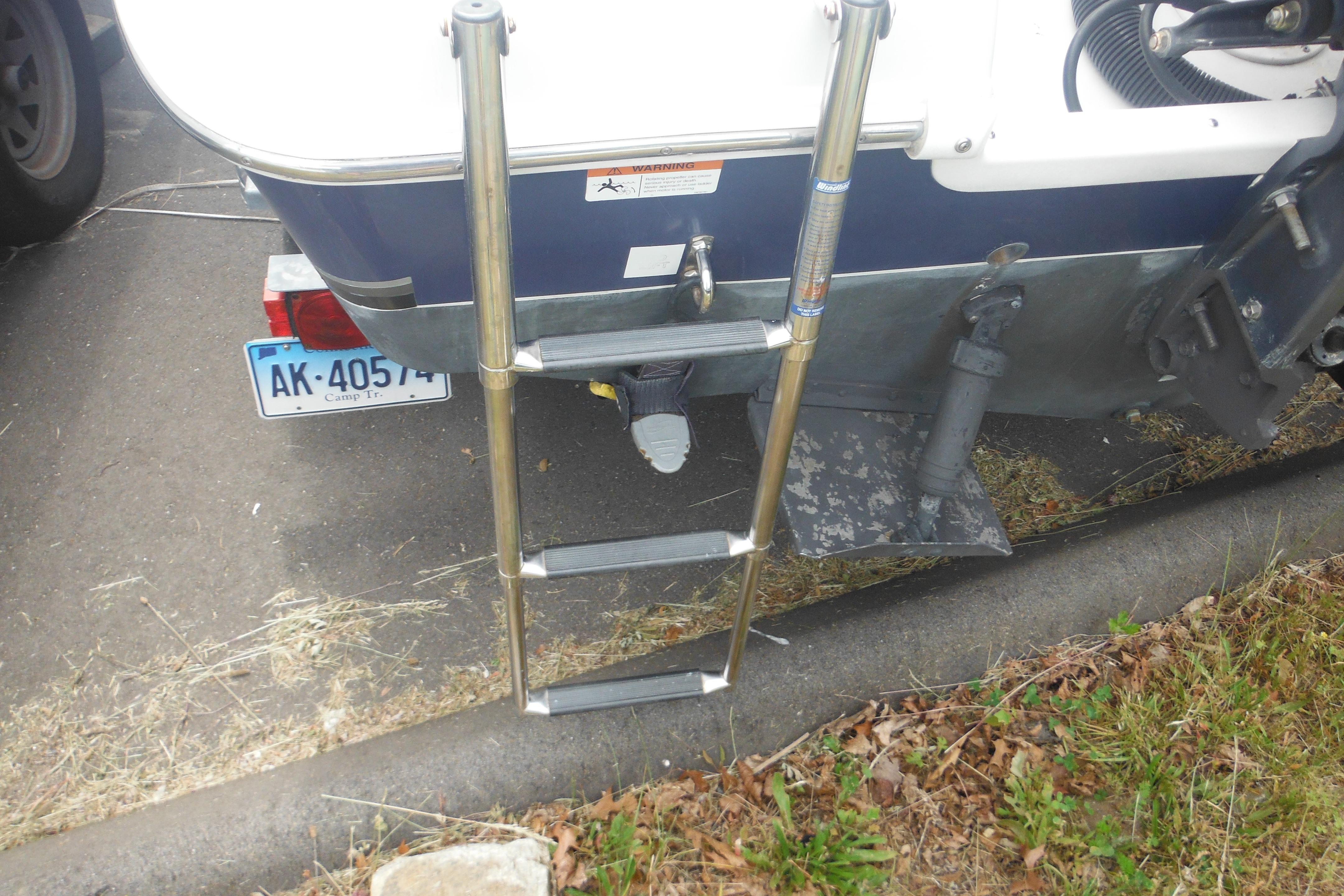 Rear view of a 2005 Seaswirl Striper 2101 Walkaround O/B with ladder and trailer.