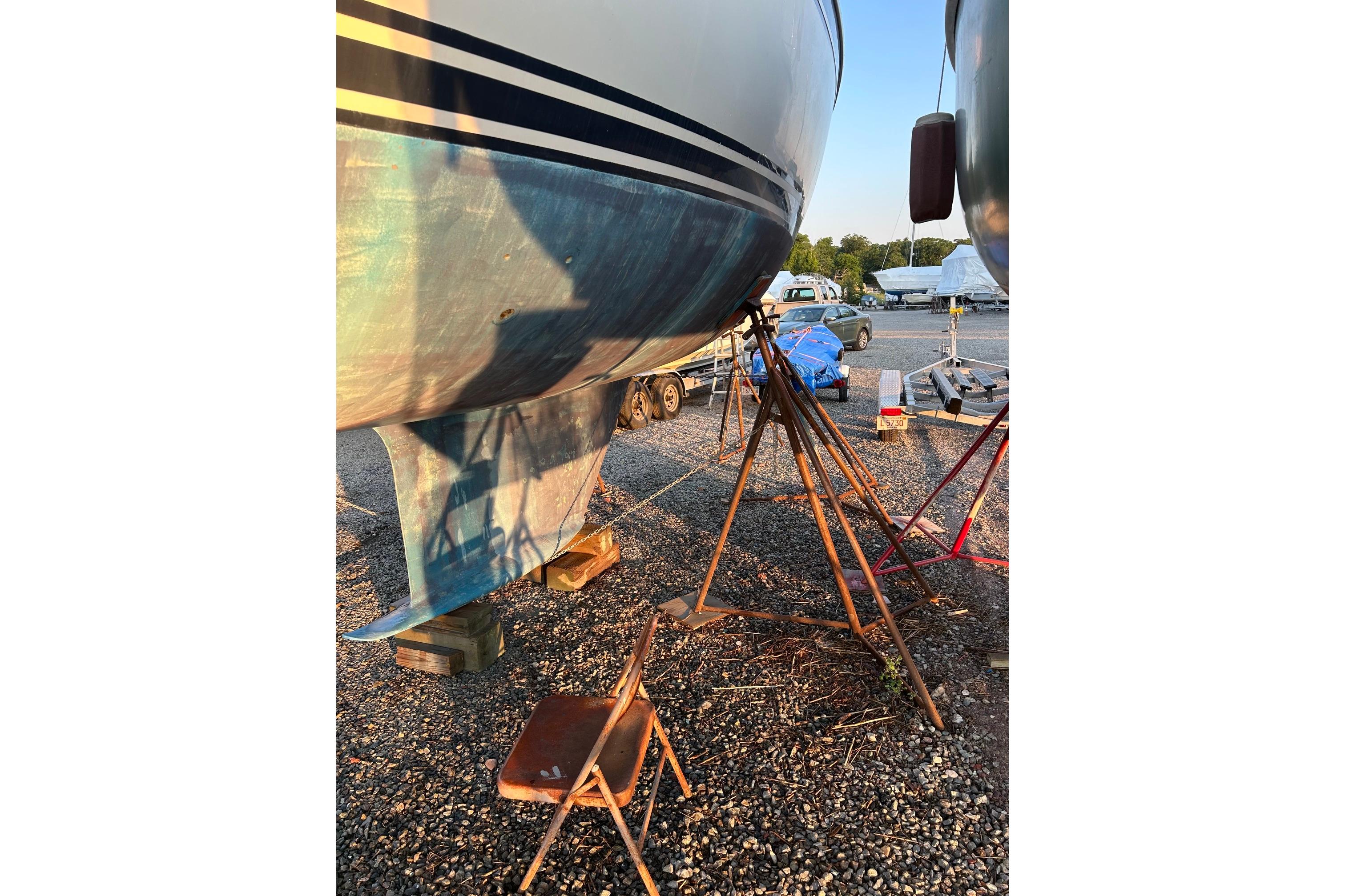 1987 Ericson 38-200 sailboat on stands, hull view in a boatyard.