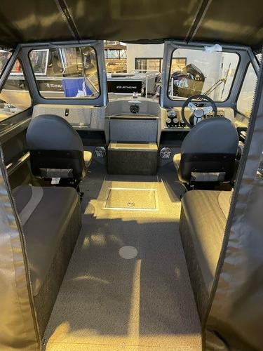 2024 Spartan 185 Astoria boat interior with seating and steering console.