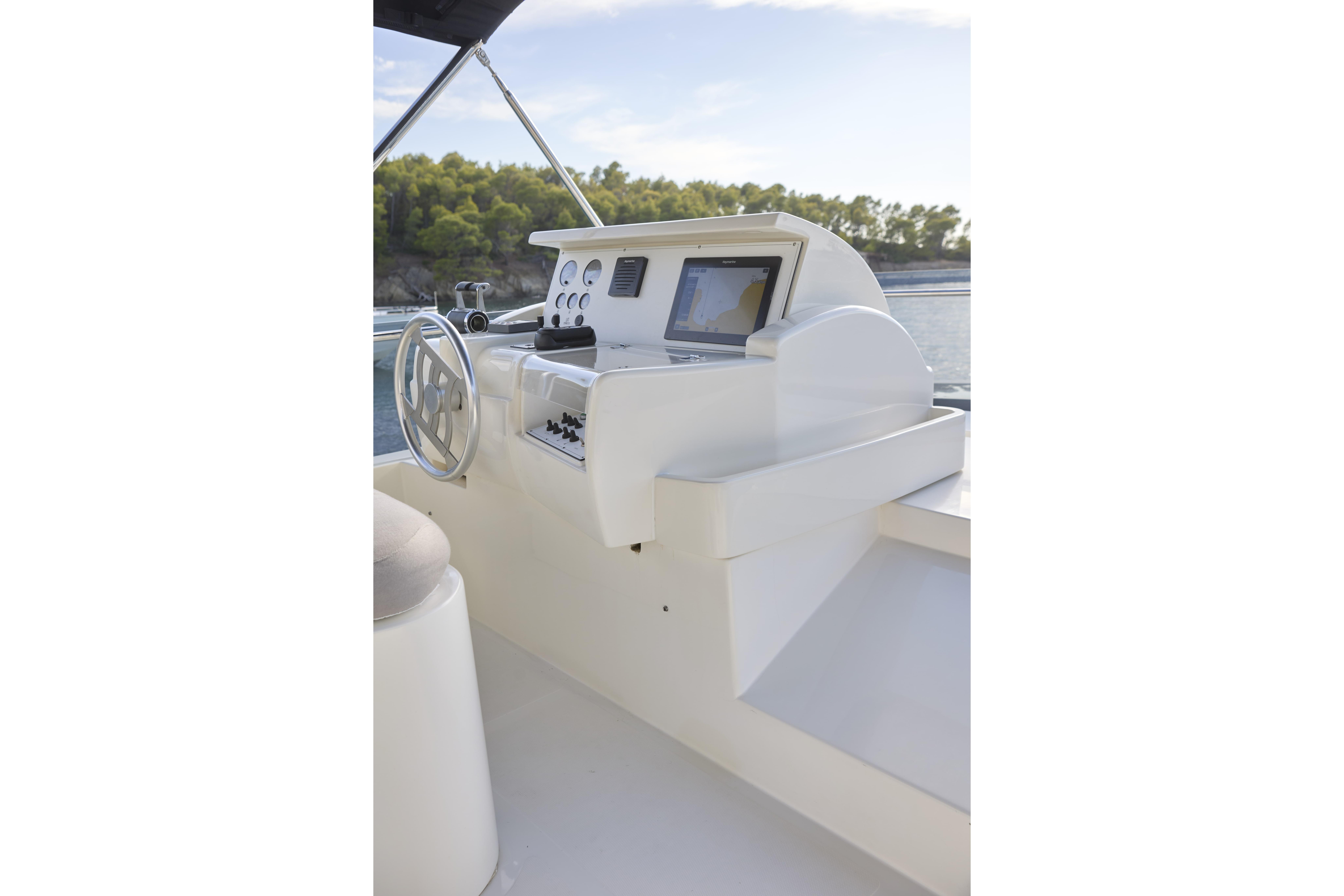 Helm of 2004 Ferretti Yachts 680 with navigation equipment and steering wheel.