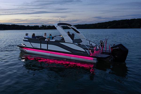 Manufacturer Provided Image: Manufacturer Provided Image: 2025 Harris Grand Mariner 250 pontoon boat with pink LED lights on a lake at dusk.