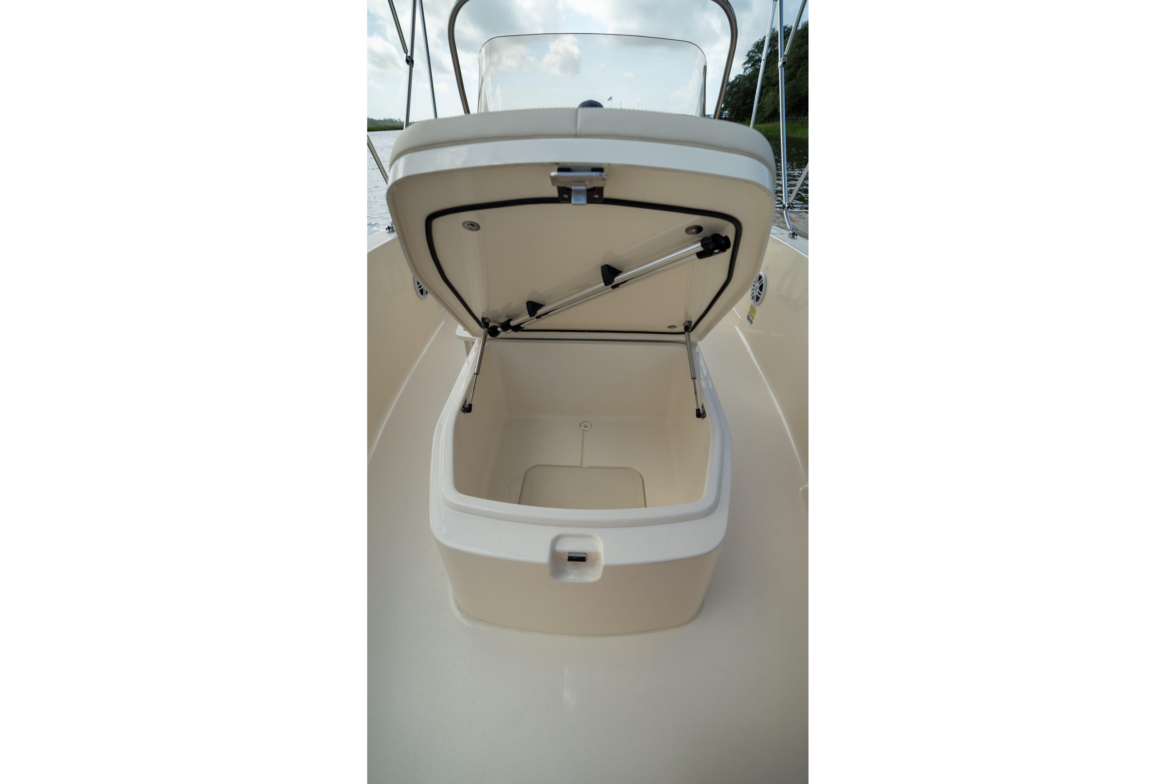 Open storage compartment on 2026 Scout 188 Sportfish boat, showcasing interior space.