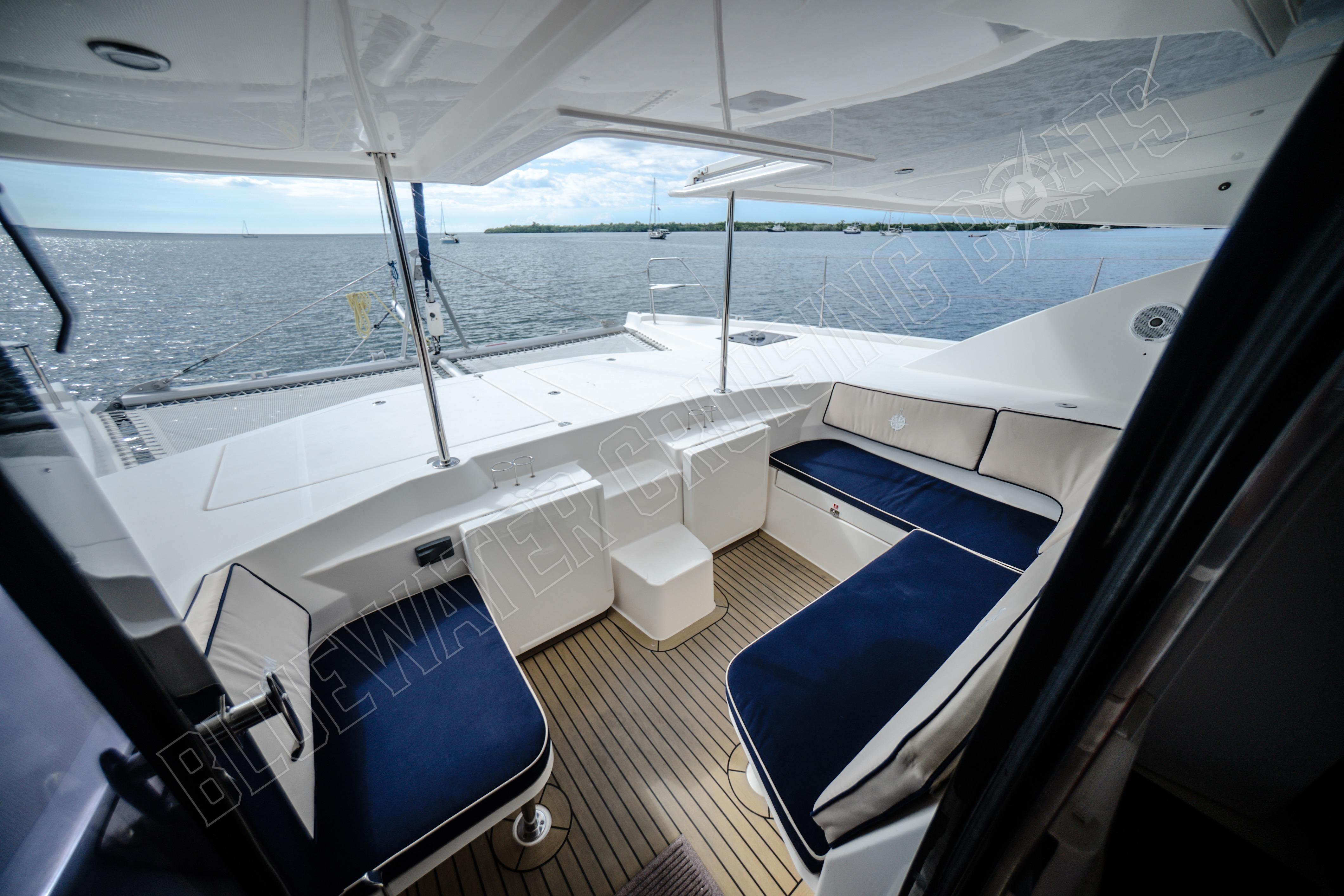 Luxurious 2015 Leopard 48 yacht interior with elegant seating and ocean view.