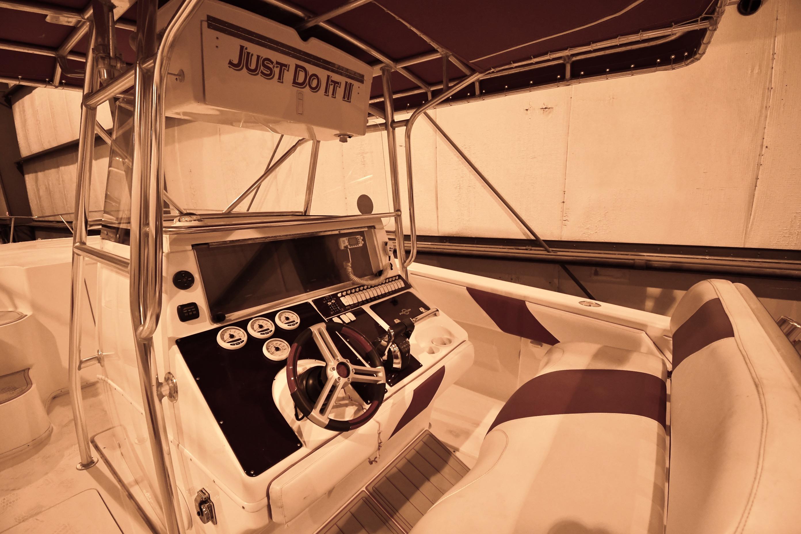 2001 Fountain 38 Center Console boat interior with steering wheel and seating.