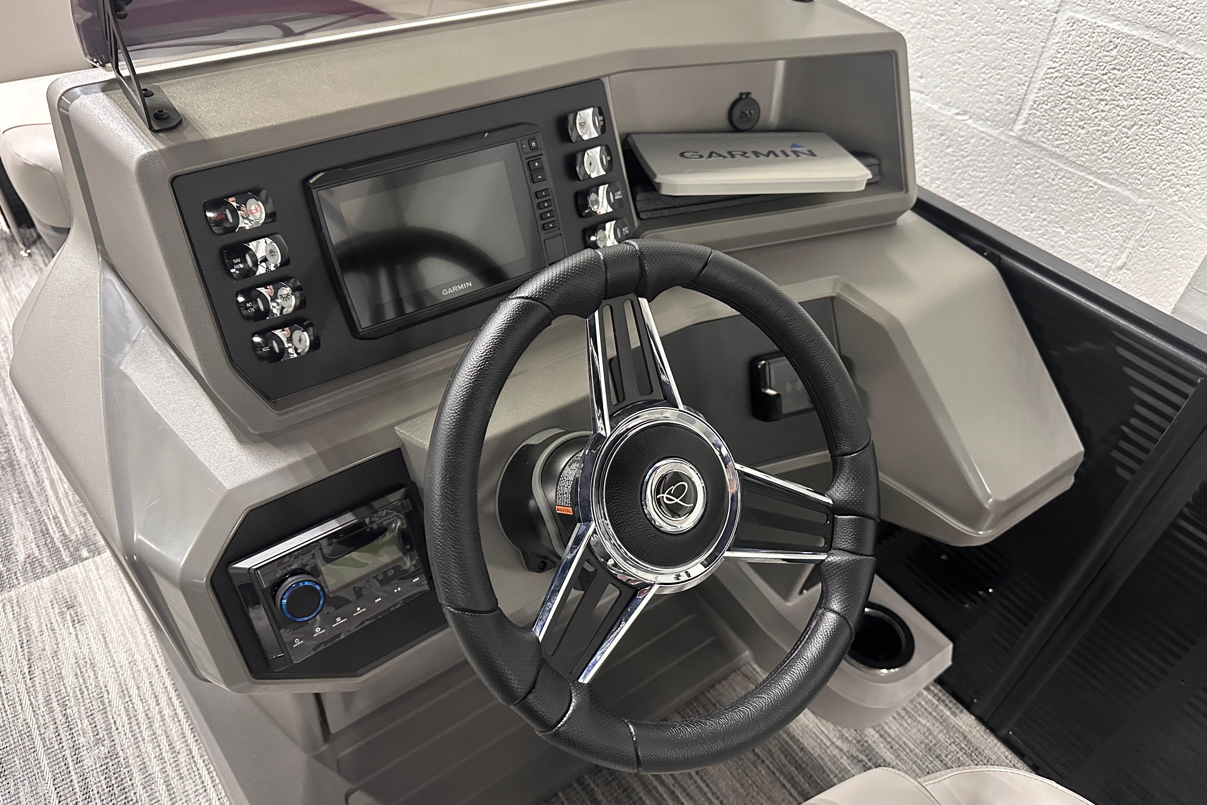 Steering console of 2025 Qwest 18 XRE Cruise boat with Garmin navigation system.