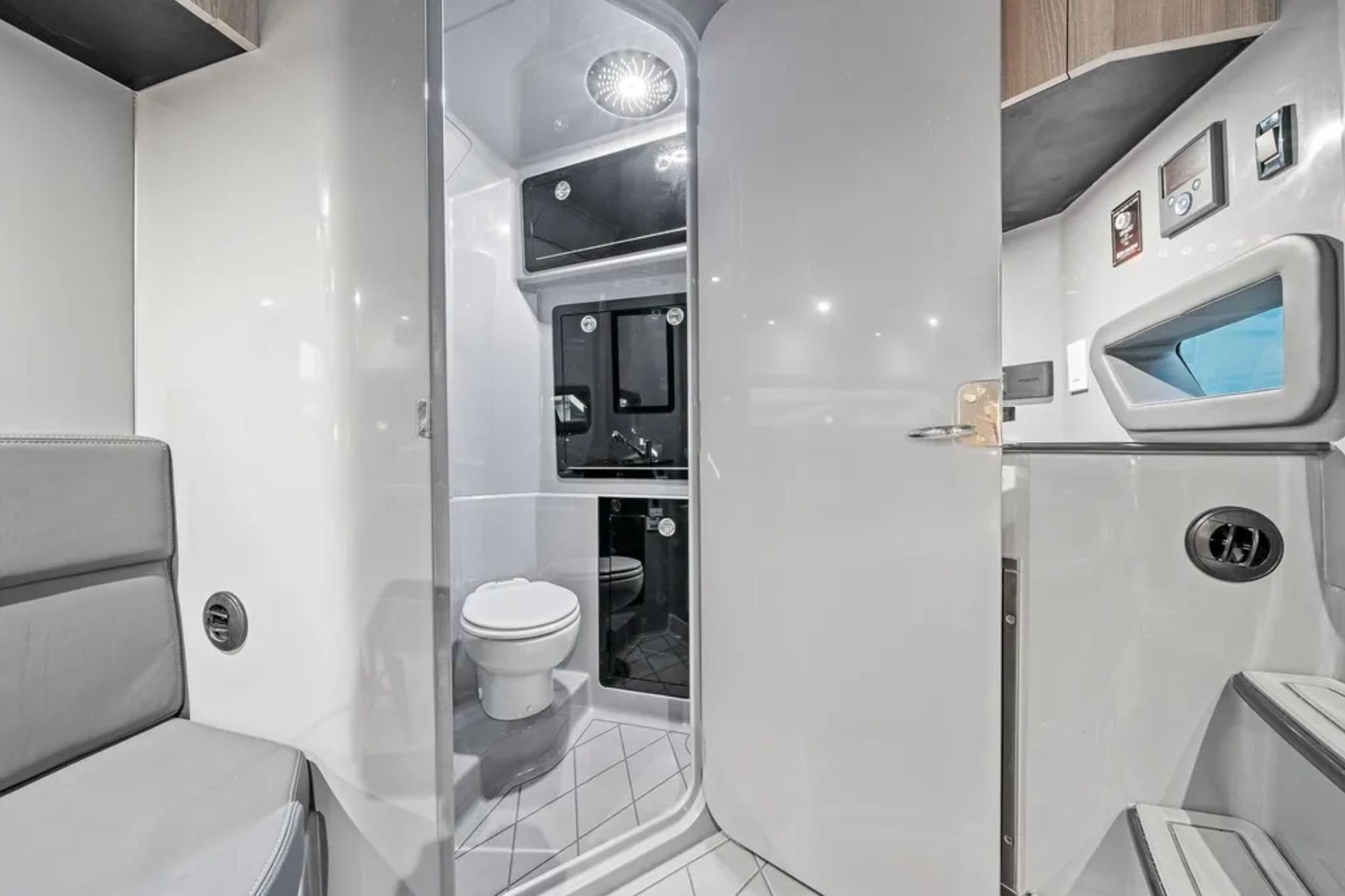 Modern bathroom interior in 2026 Deep Impact 499 Sport boat, featuring sleek design and amenities.