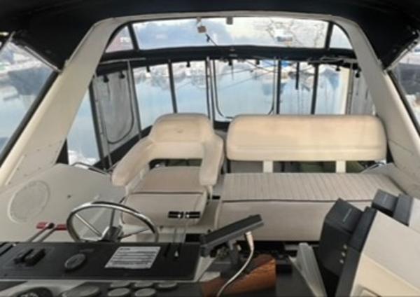 1991 Carver 33 Aft Cabin Motor Yacht interior with helm and seating area.