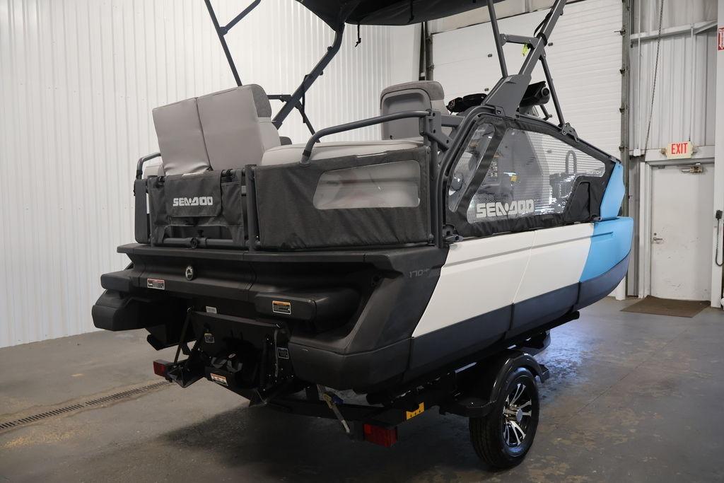 2023 Sea-Doo Switch Sport Compact in a garage, showcasing rear design and seating.