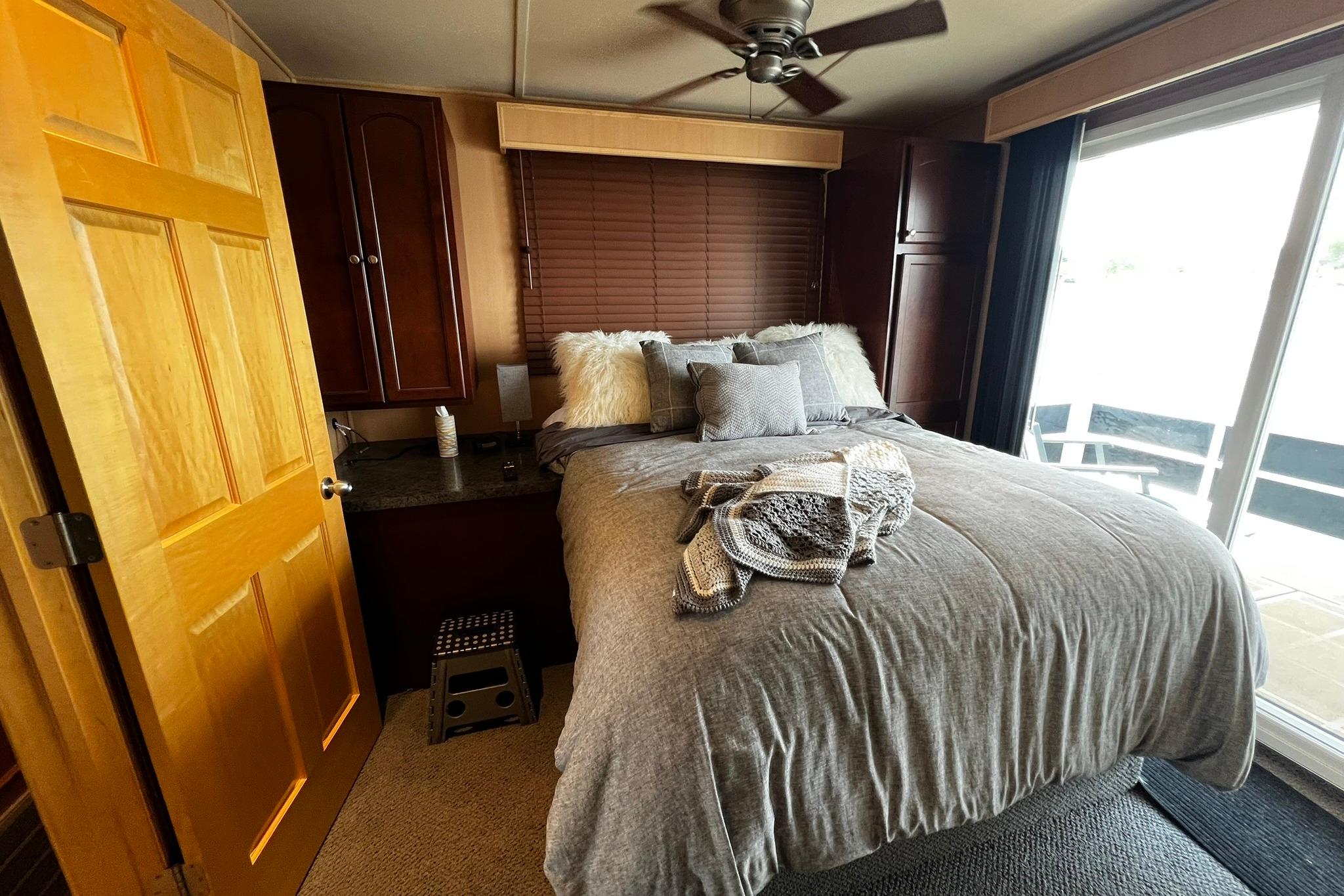 Cozy bedroom in 2010 Skipperliner 480 Flybridge with plush bedding and modern decor.
