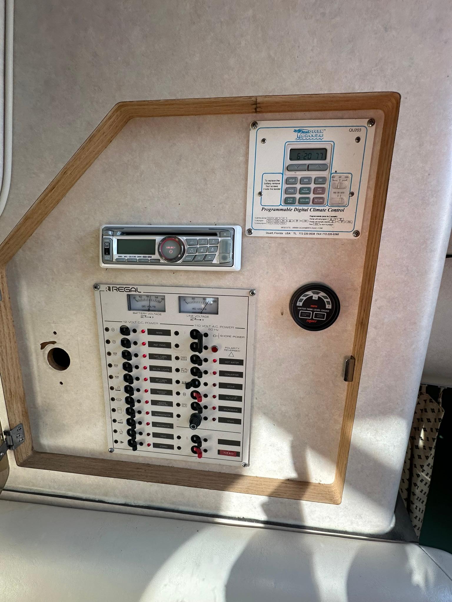 Control panel of a 1997 Regal 292 Commodore boat with switches and gauges.