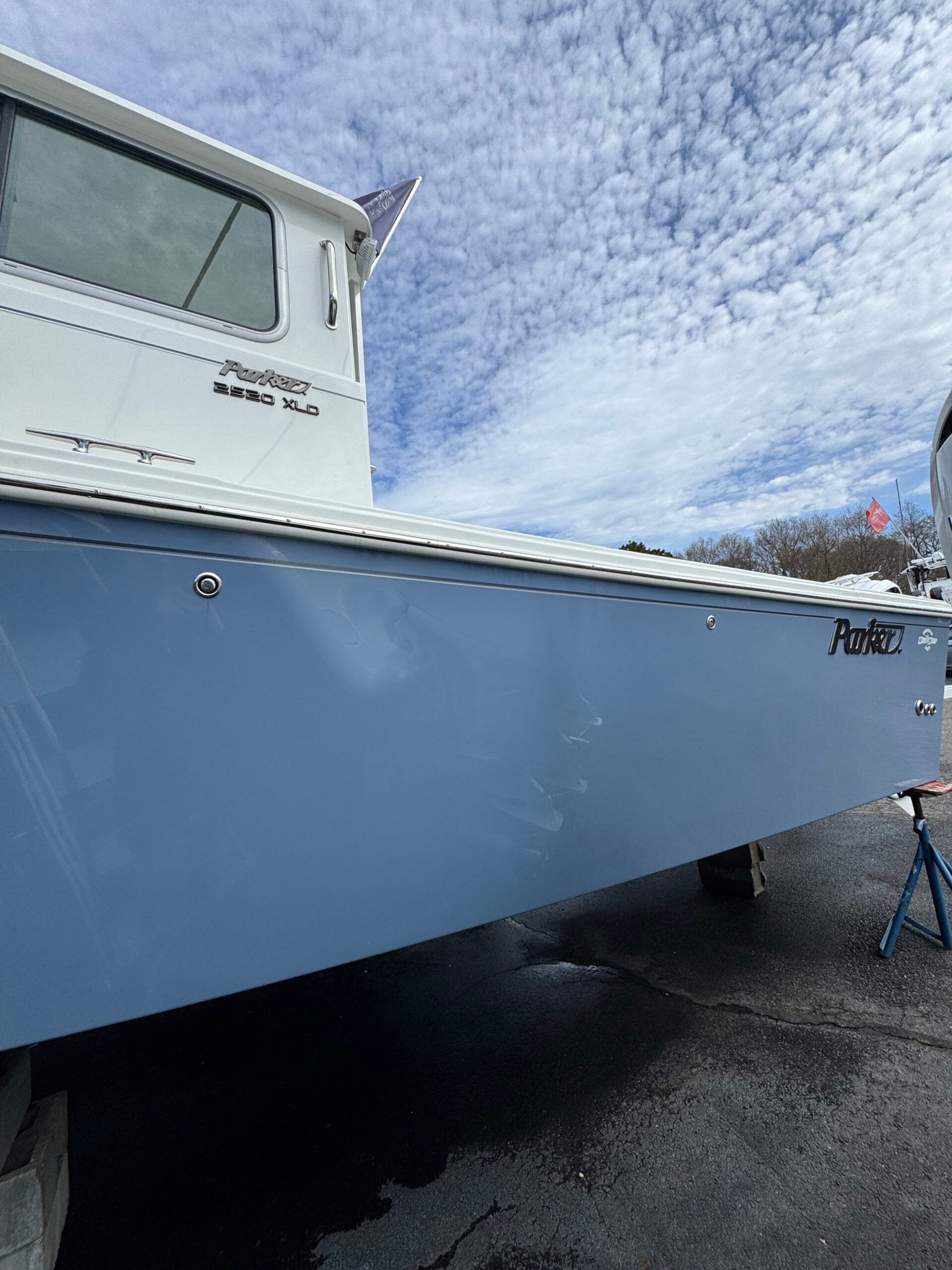 Boat with blue hull and white superstructure on a stand.