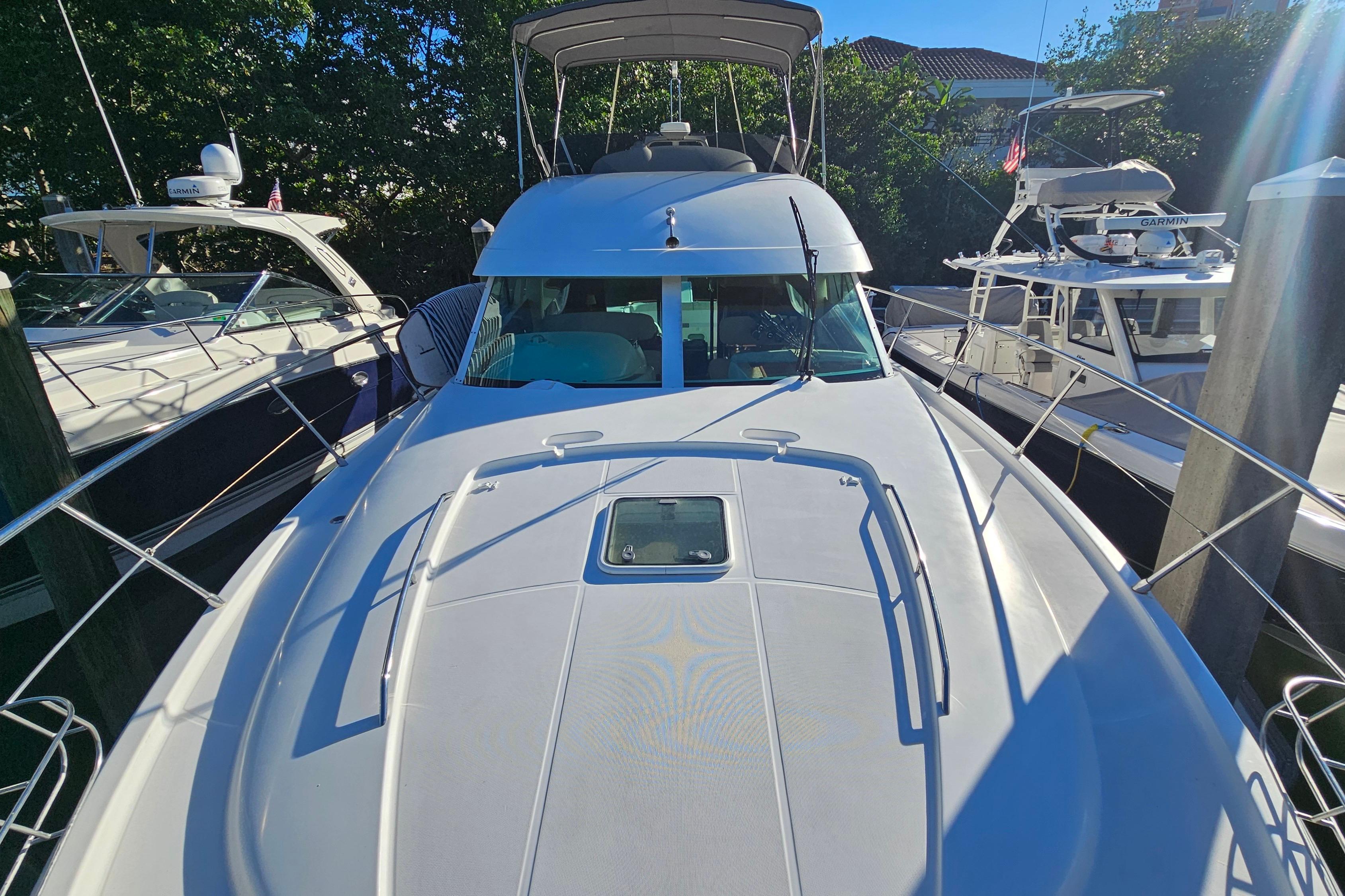 2005 Prestige 46 yacht docked, surrounded by other boats, under clear blue sky.