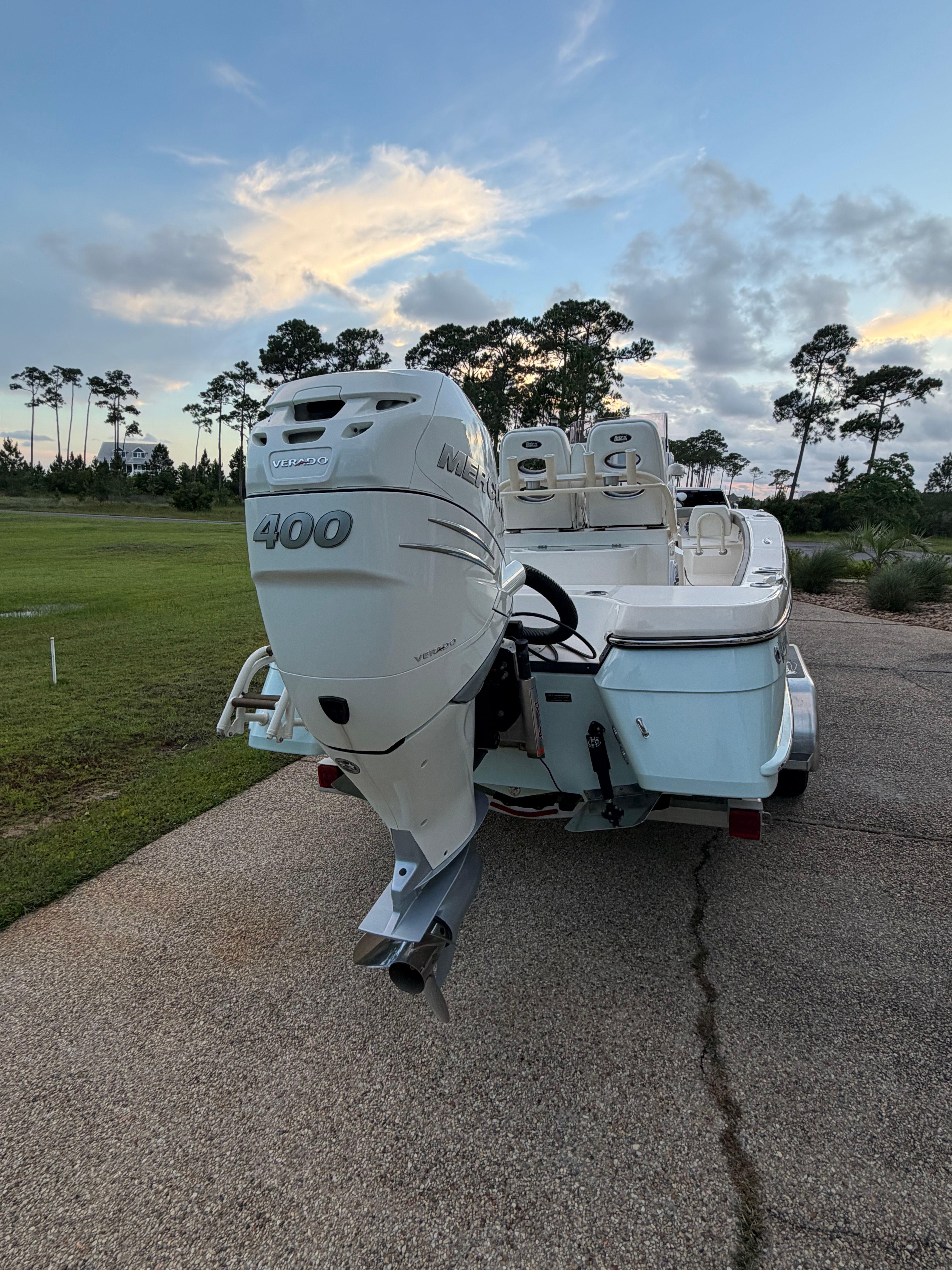 2022 BlackJack 256 Coastal boat with 400 HP engine outdoors.