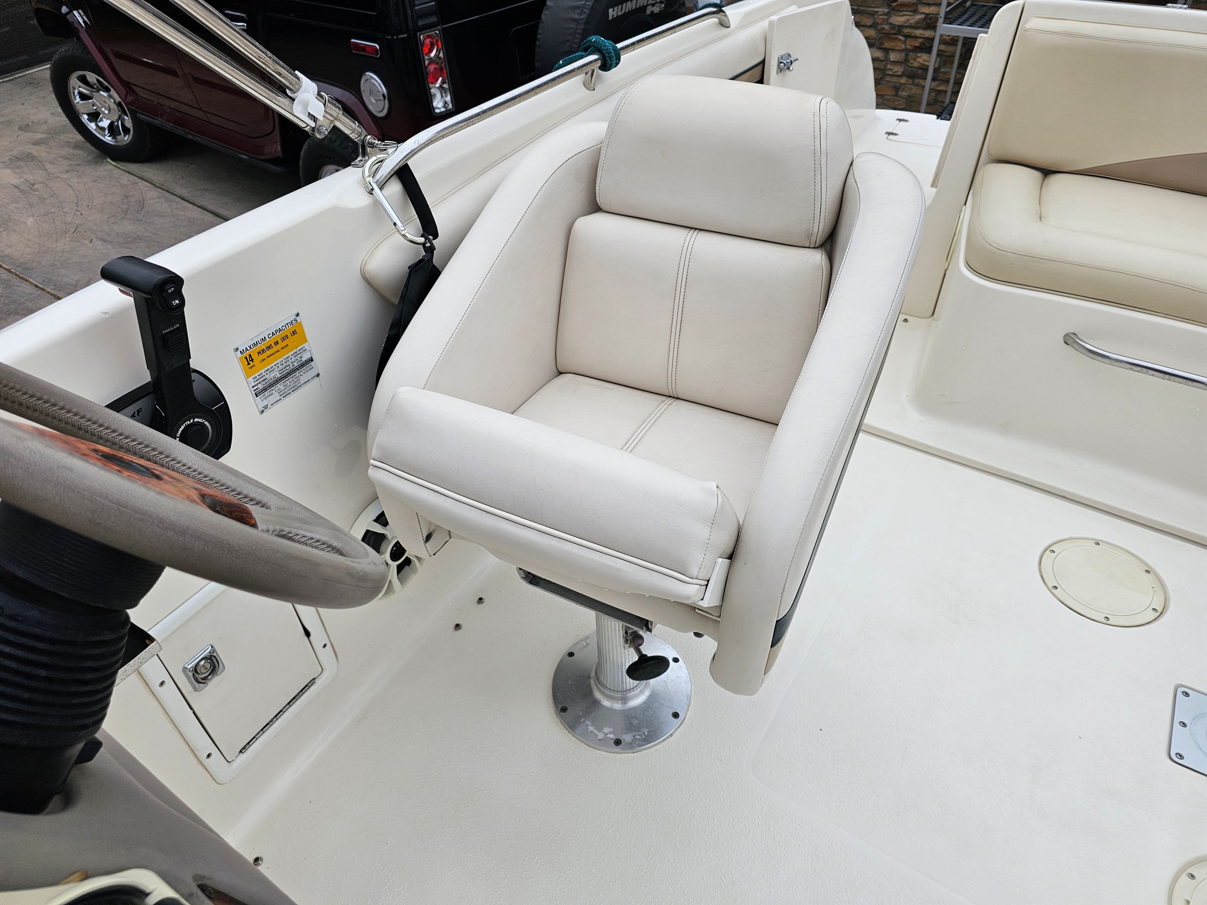Interior of a 1998 Chaparral Sunesta 252 boat with white captain's chair.