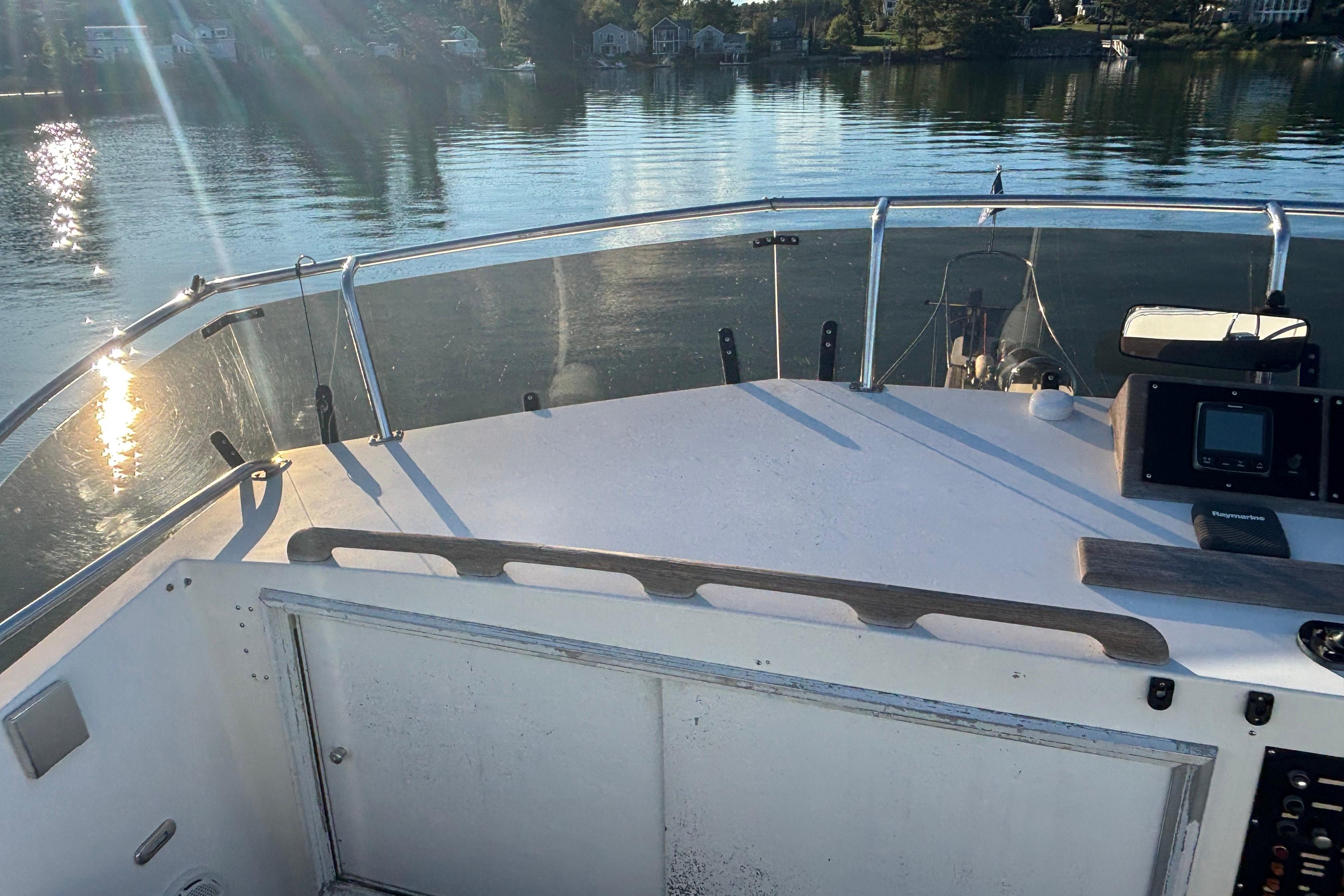 1989 Grand Banks 46 Classic yacht deck with serene water view and sunlight reflections.