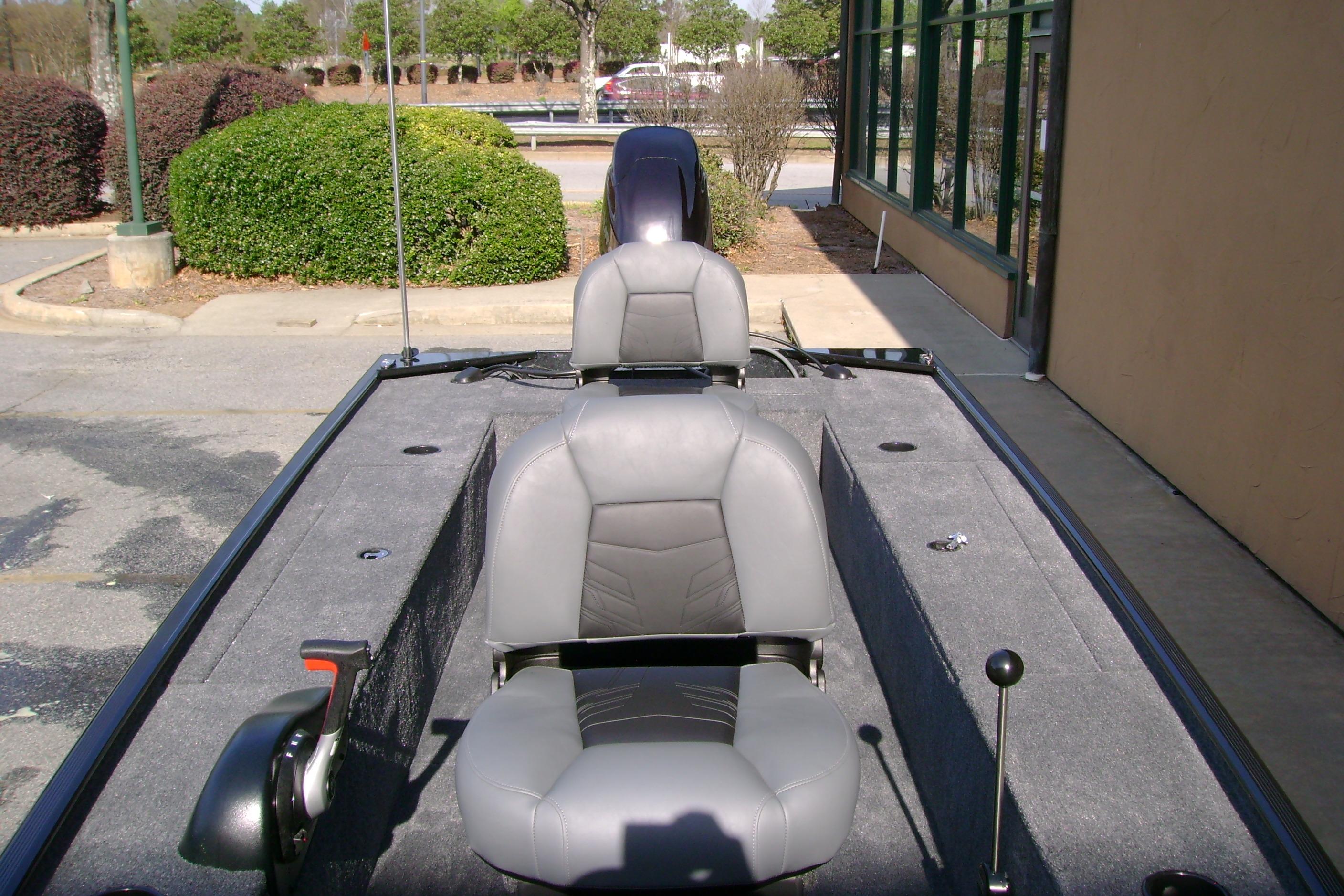 2026 Tracker Panfish 17 boat with gray seating, parked outdoors.