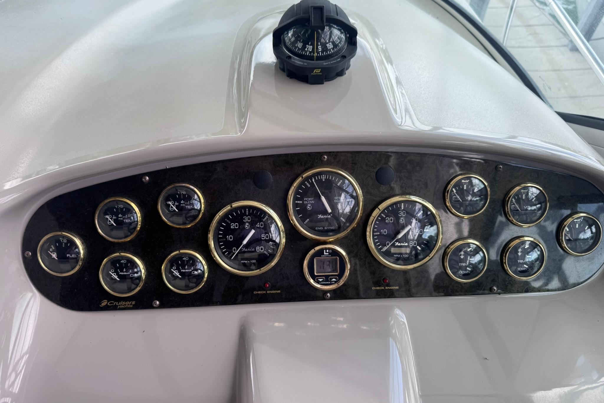 Dashboard of a 2002 Cruisers Yachts 3275 Express with gauges and compass.