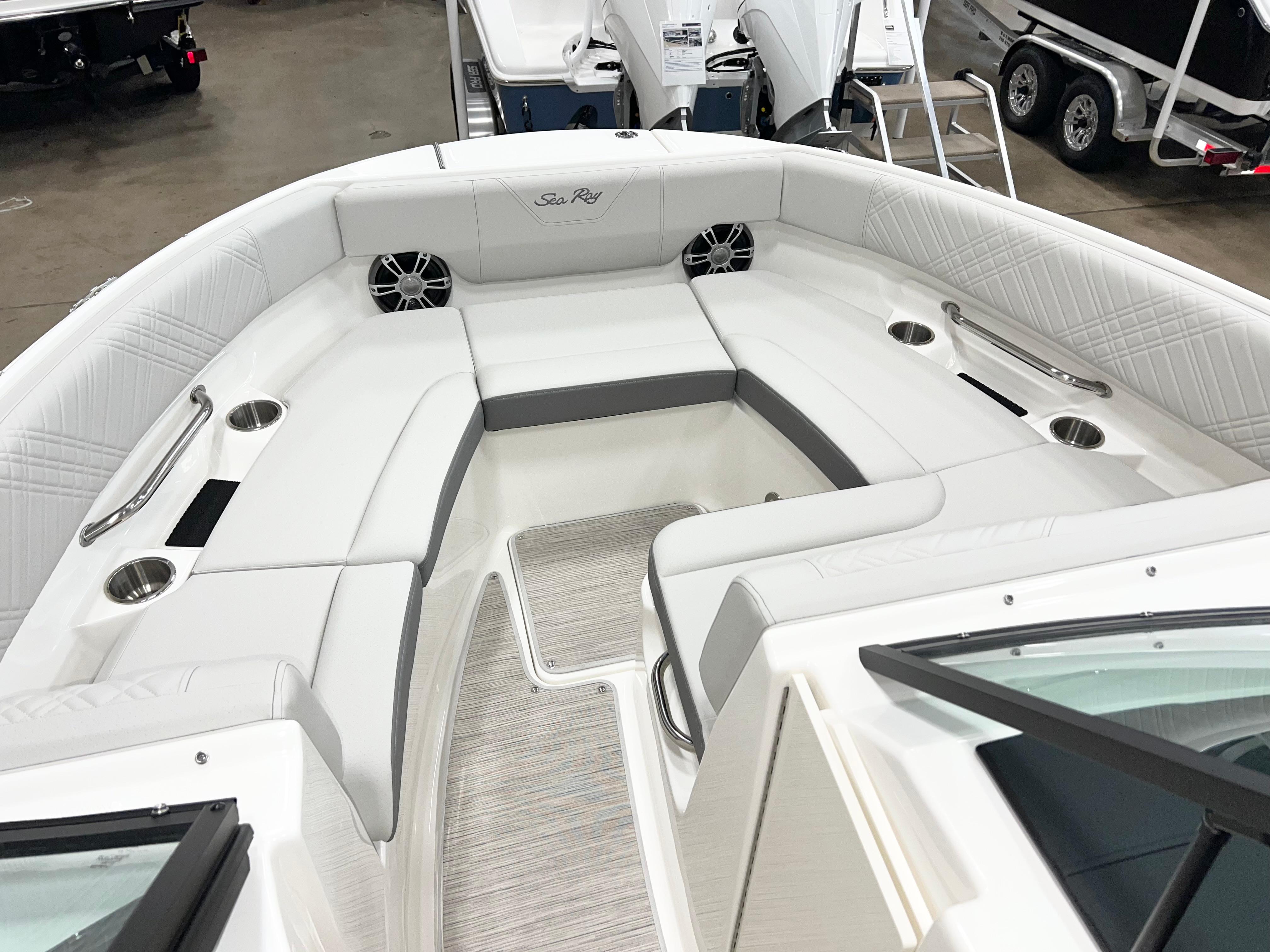 2025 Sea Ray SDX 250 boat interior with white seating and cup holders.