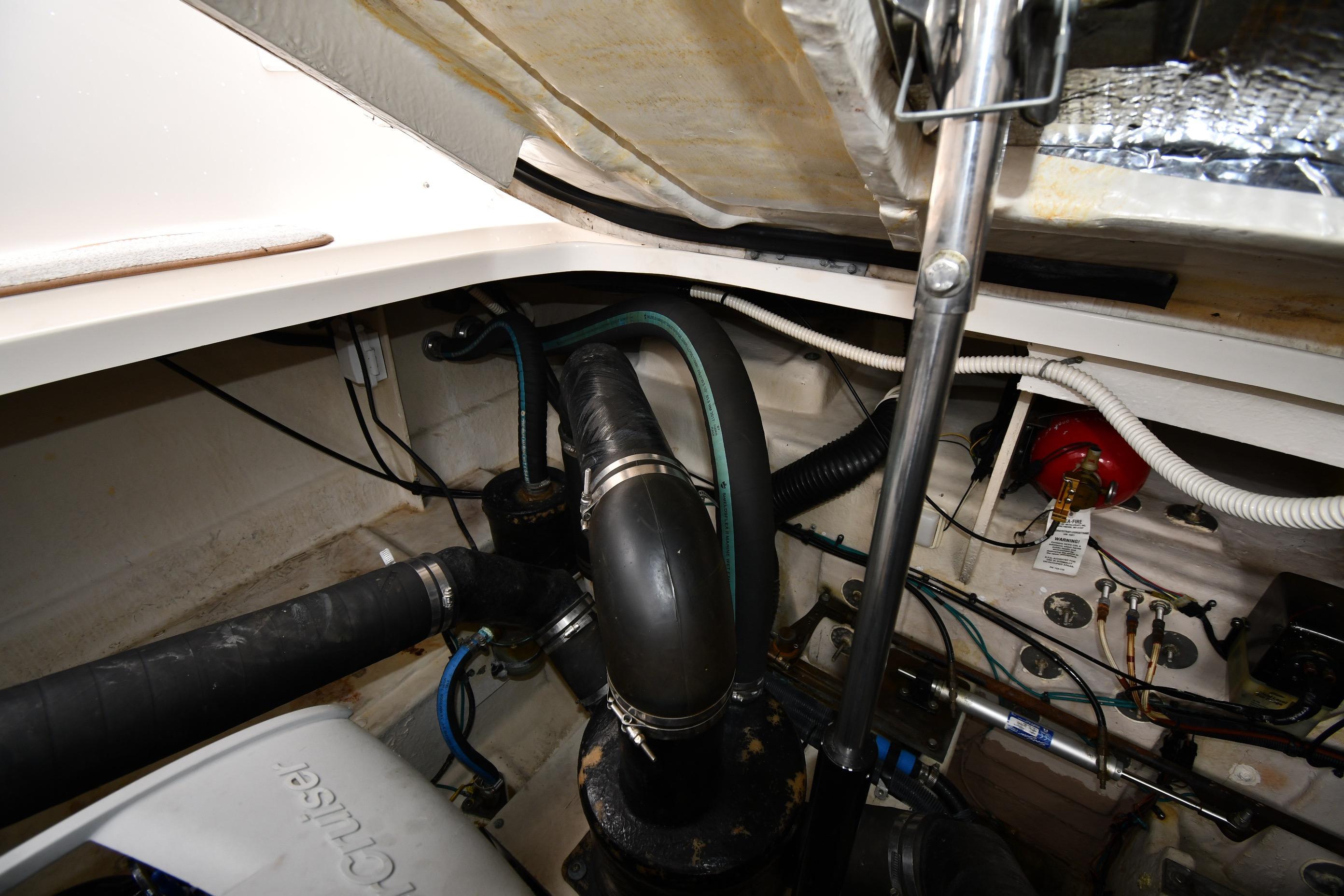 Engine compartment of a 2008 Sea Ray Sundancer 350 with visible hoses and wiring.