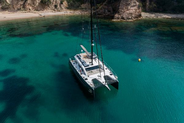 Luxury Privilege Signature 580 catamaran anchored in clear turquoise waters, 2025 model.
