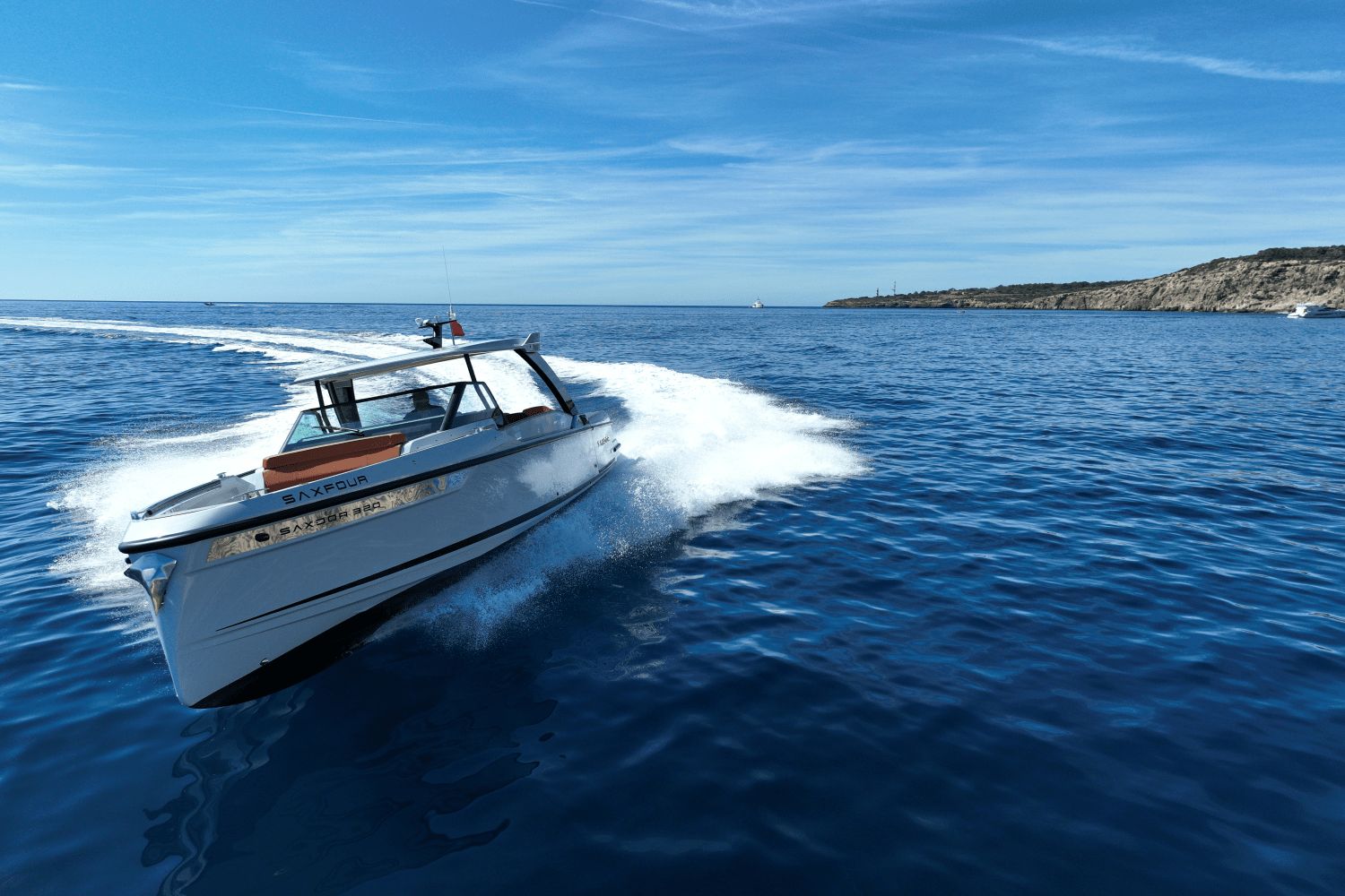 A 2027 Saxdor SX320 GTO speeds across the blue sea under a clear sky.