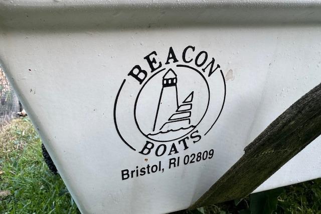 Beacon Boats Pram 1999 logo on white hull, Bristol, RI 02809.