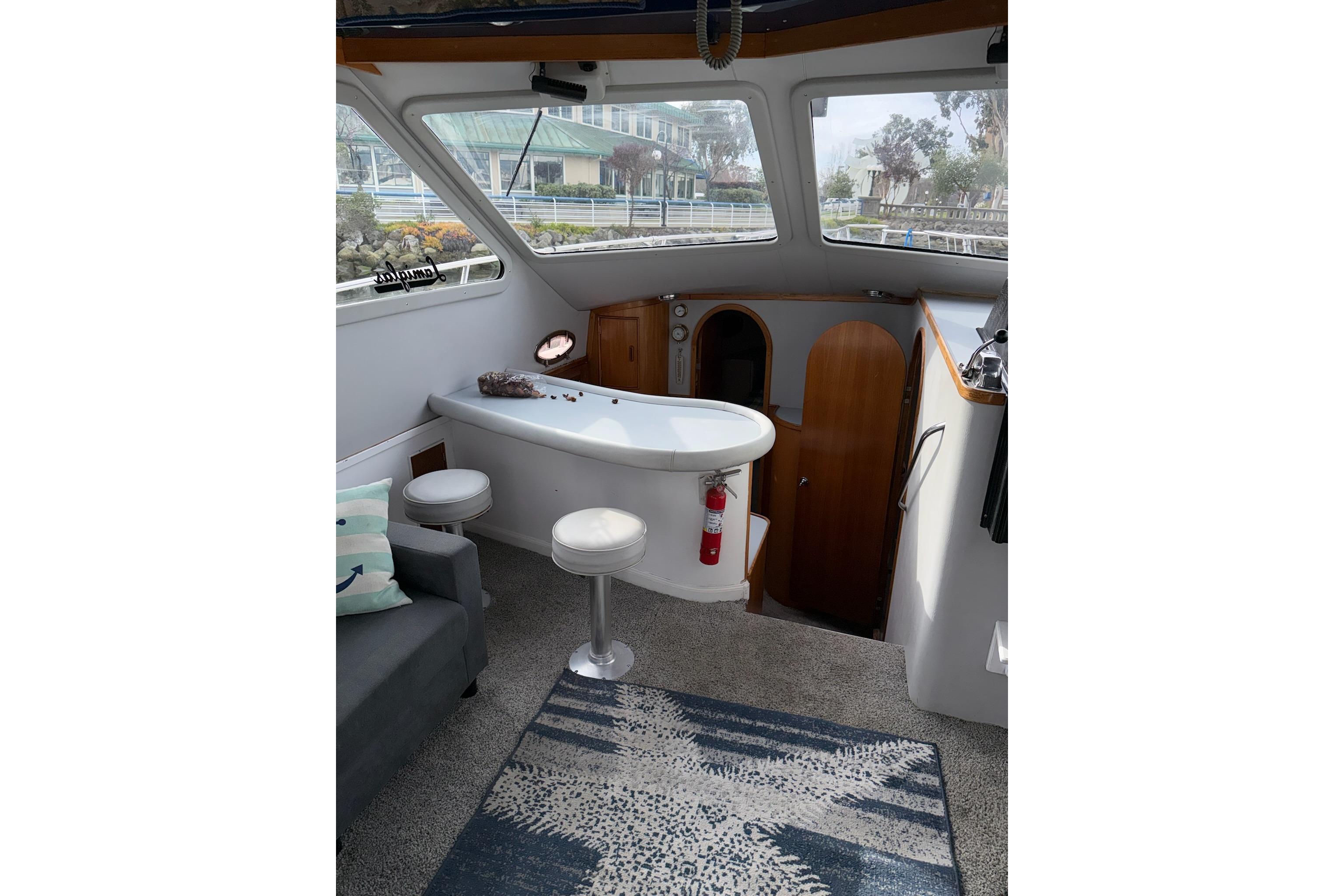 Interior of a 1990 Mediterranean Sport Fish boat with seating and a small table.