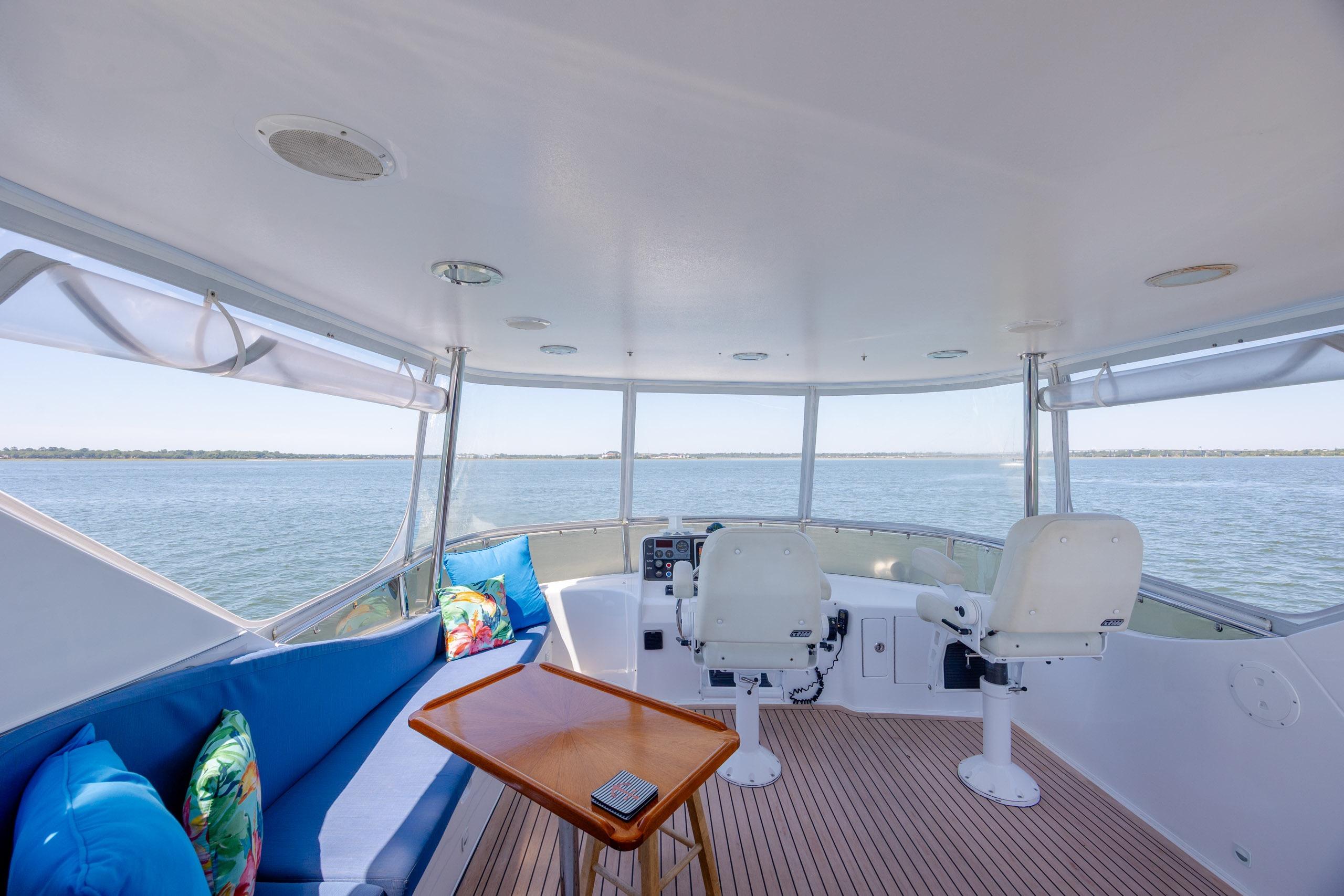 Spacious cockpit of 2005 Ocean Alexander 52 Sedan yacht with seating and ocean view.