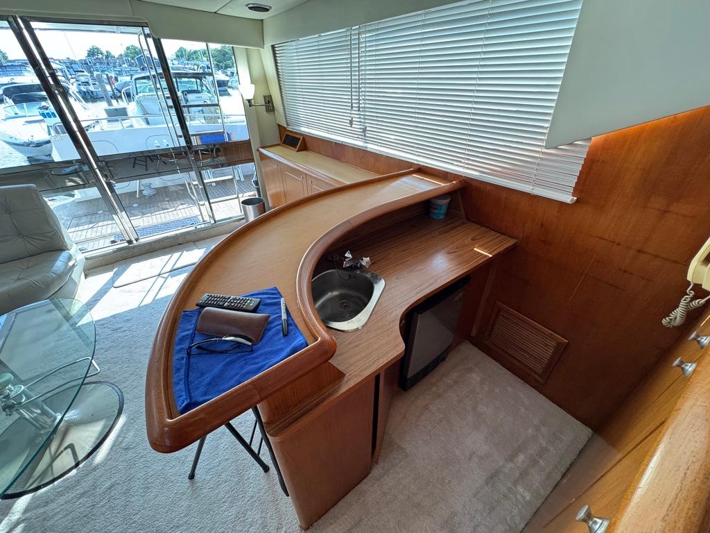 Interior of 1989 Birchwood 62 Cockpit Motor Yacht with kitchenette and seating area.