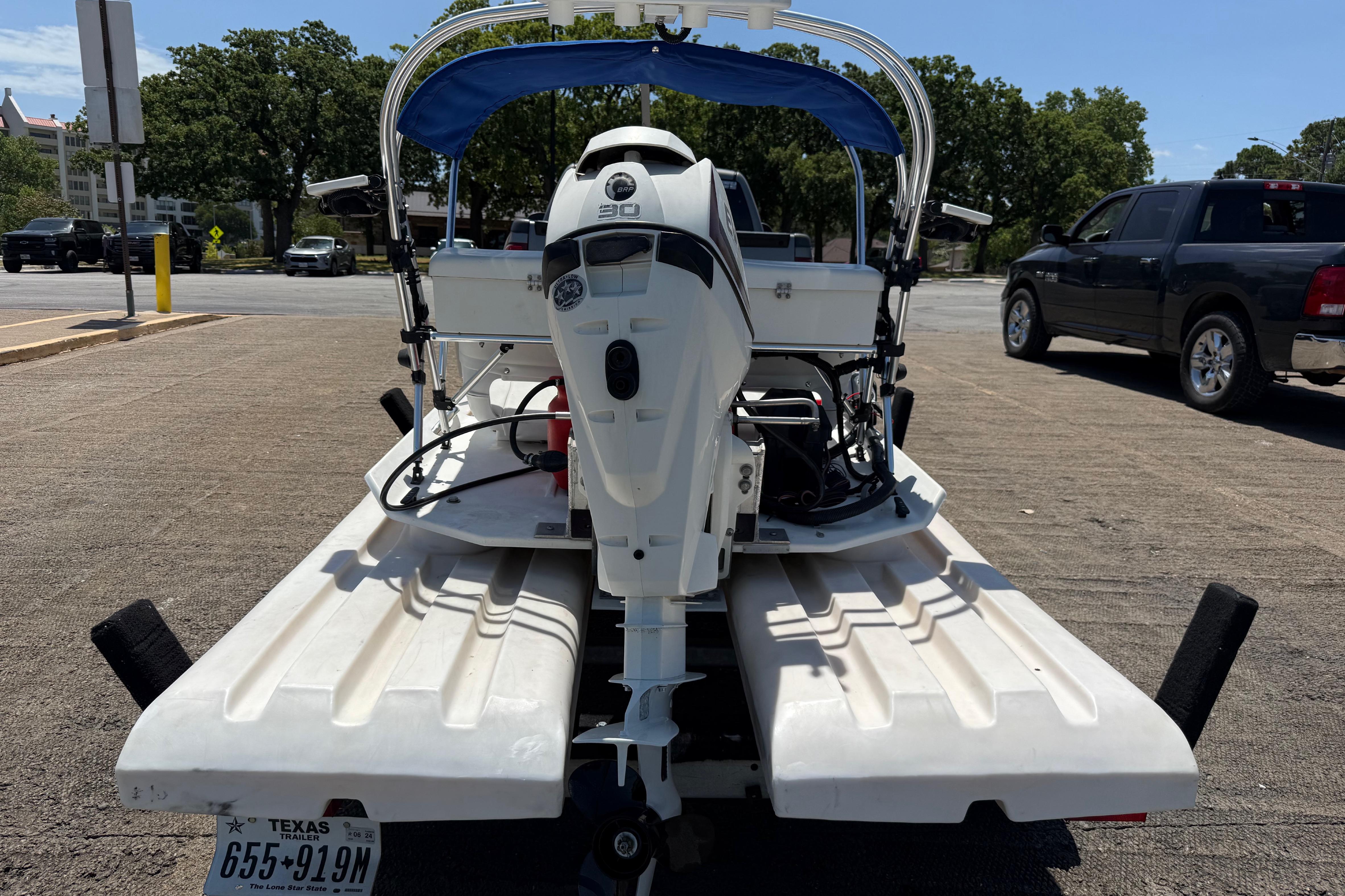 2016 CraigCat E2 Elite catamaran on trailer, parked in sunny lot.