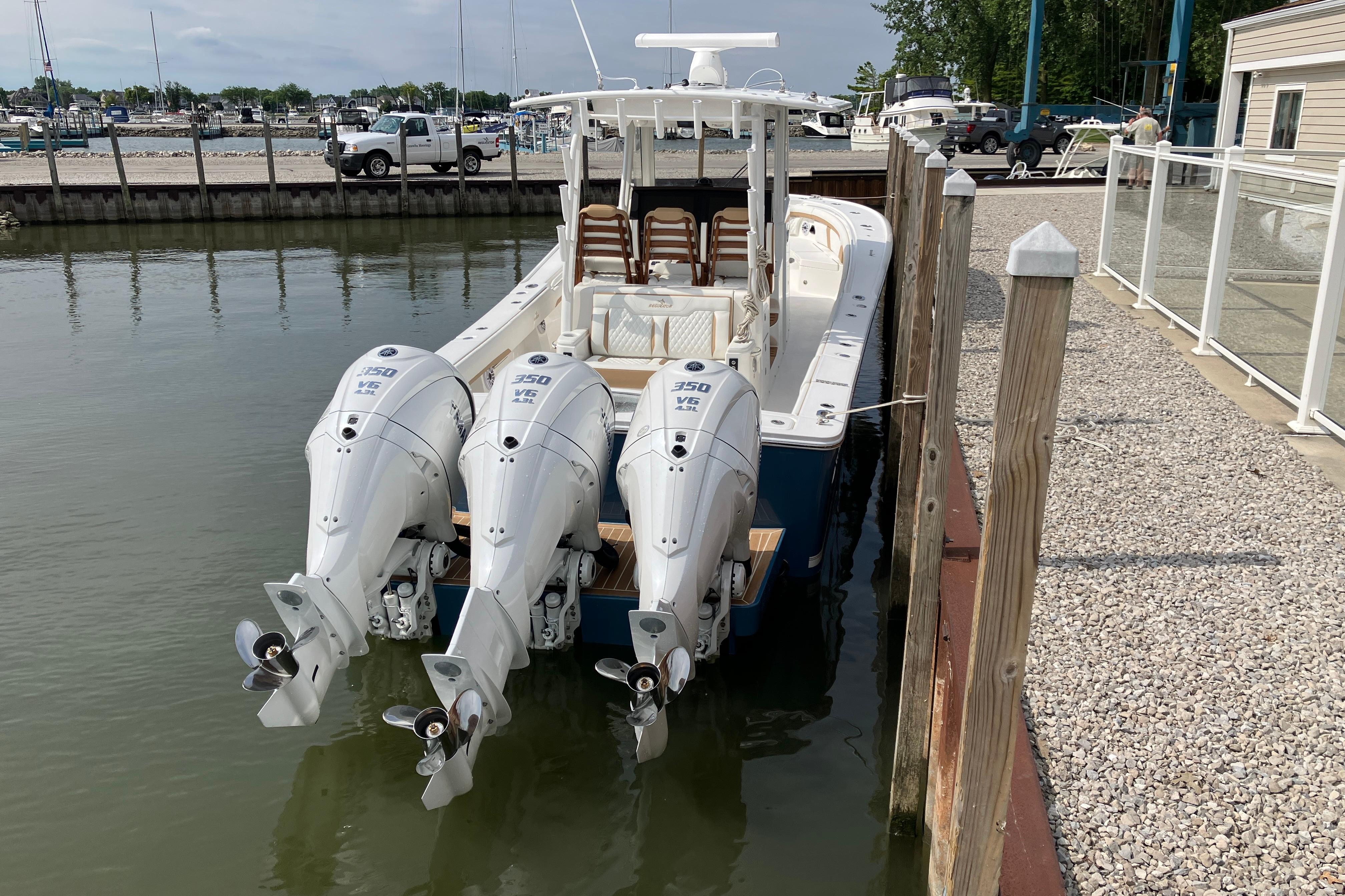 2027 Regulator 35 boat docked with triple Yamaha 350 engines.
