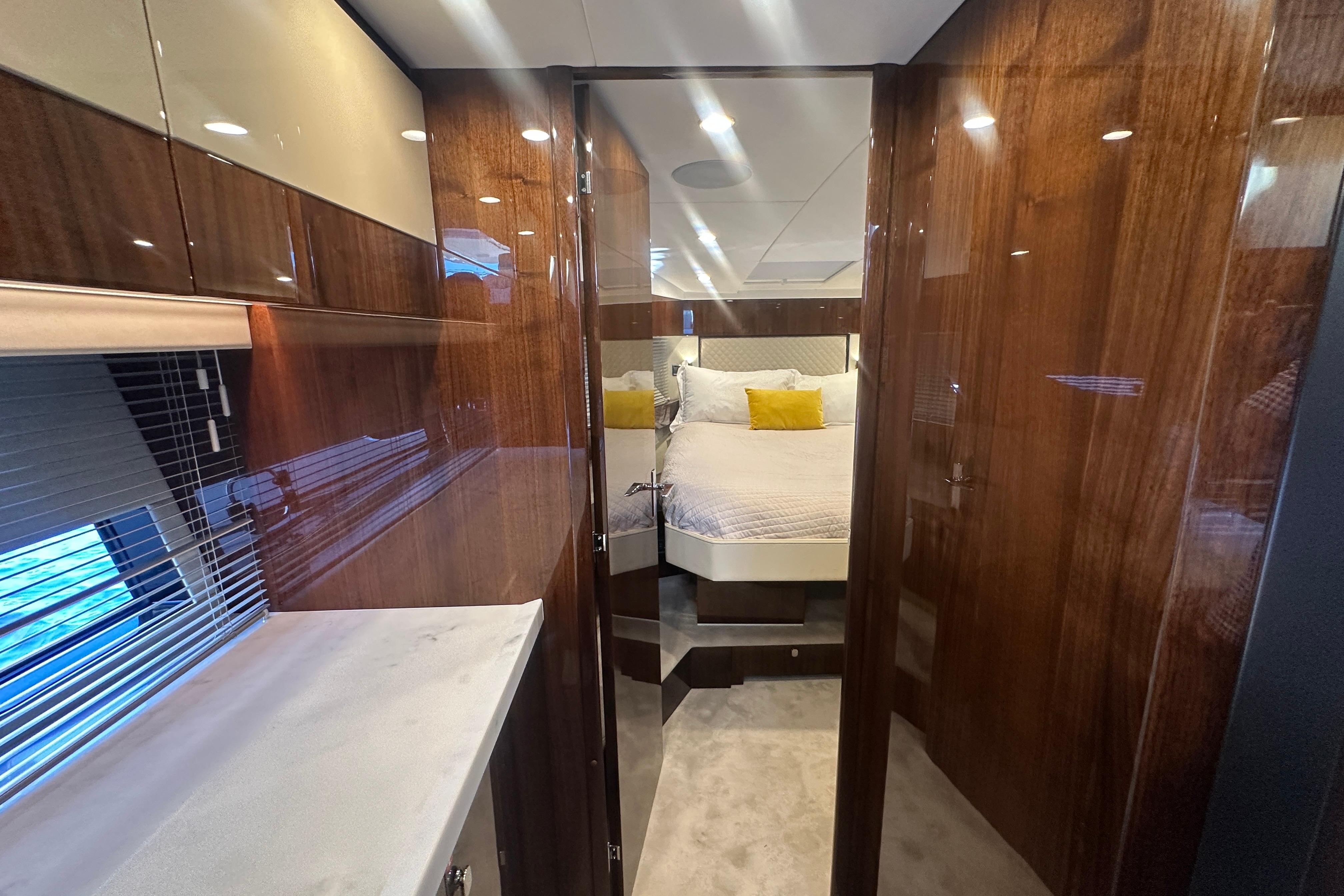 Luxurious cabin interior of 2024 Fairline Squadron 50 yacht with elegant wood finishes.