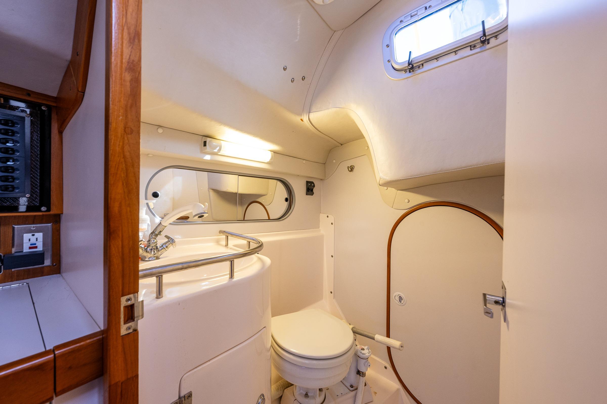 2007 J Boats J/124 yacht bathroom interior with sink, toilet, and mirror.