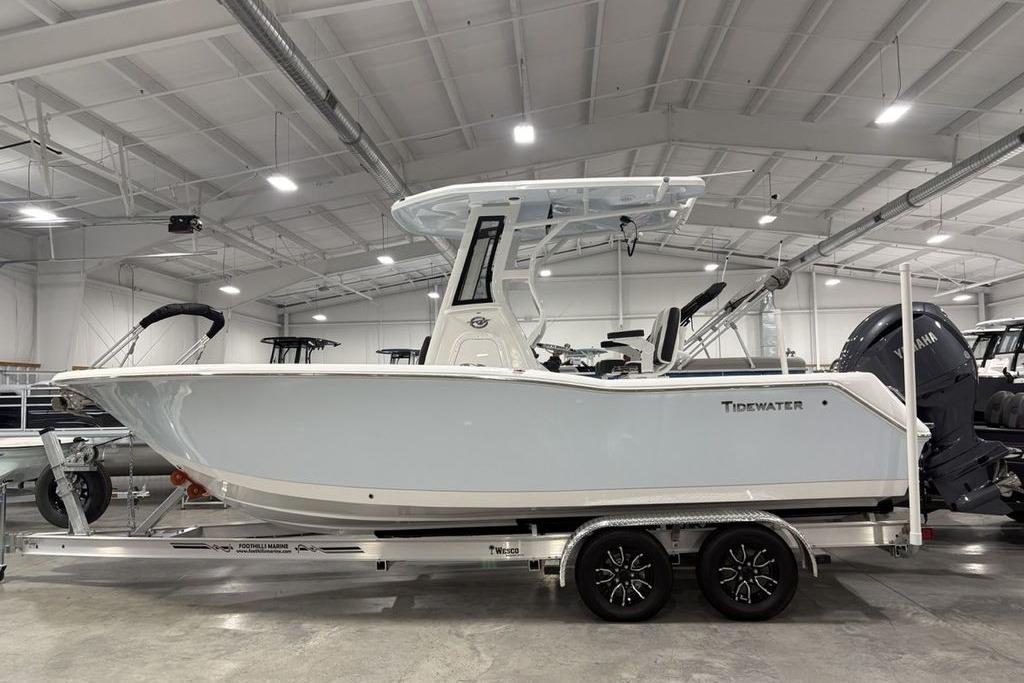 2026 Tidewater 232 CC Adventure boat in showroom, side view on trailer.