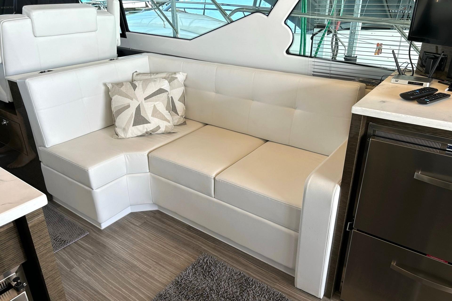 Luxurious interior of 2021 Cruisers Yachts 50 Cantius with white leather seating.
