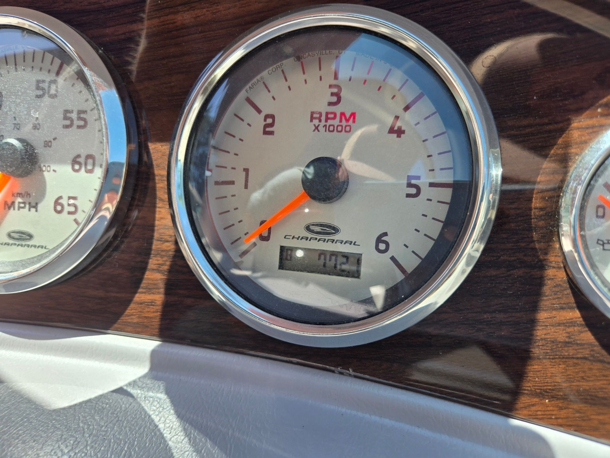 Close-up of a tachometer in a Chaparral 220 SSi boat, showing 702 RPM.