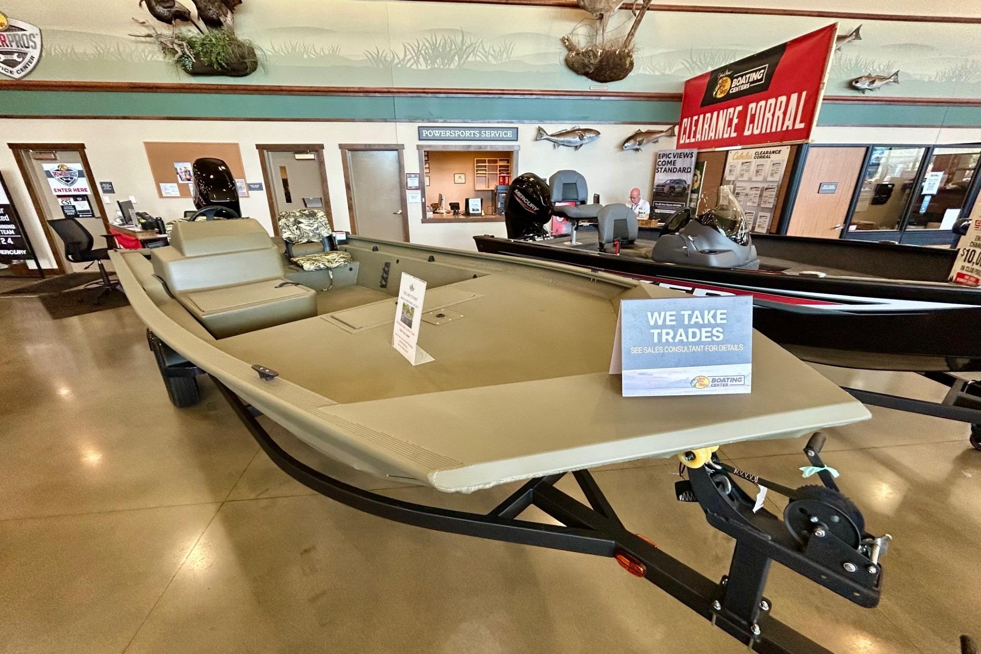 2026 Tracker Grizzly 1754 SC boat displayed in showroom with trade-in sign.
