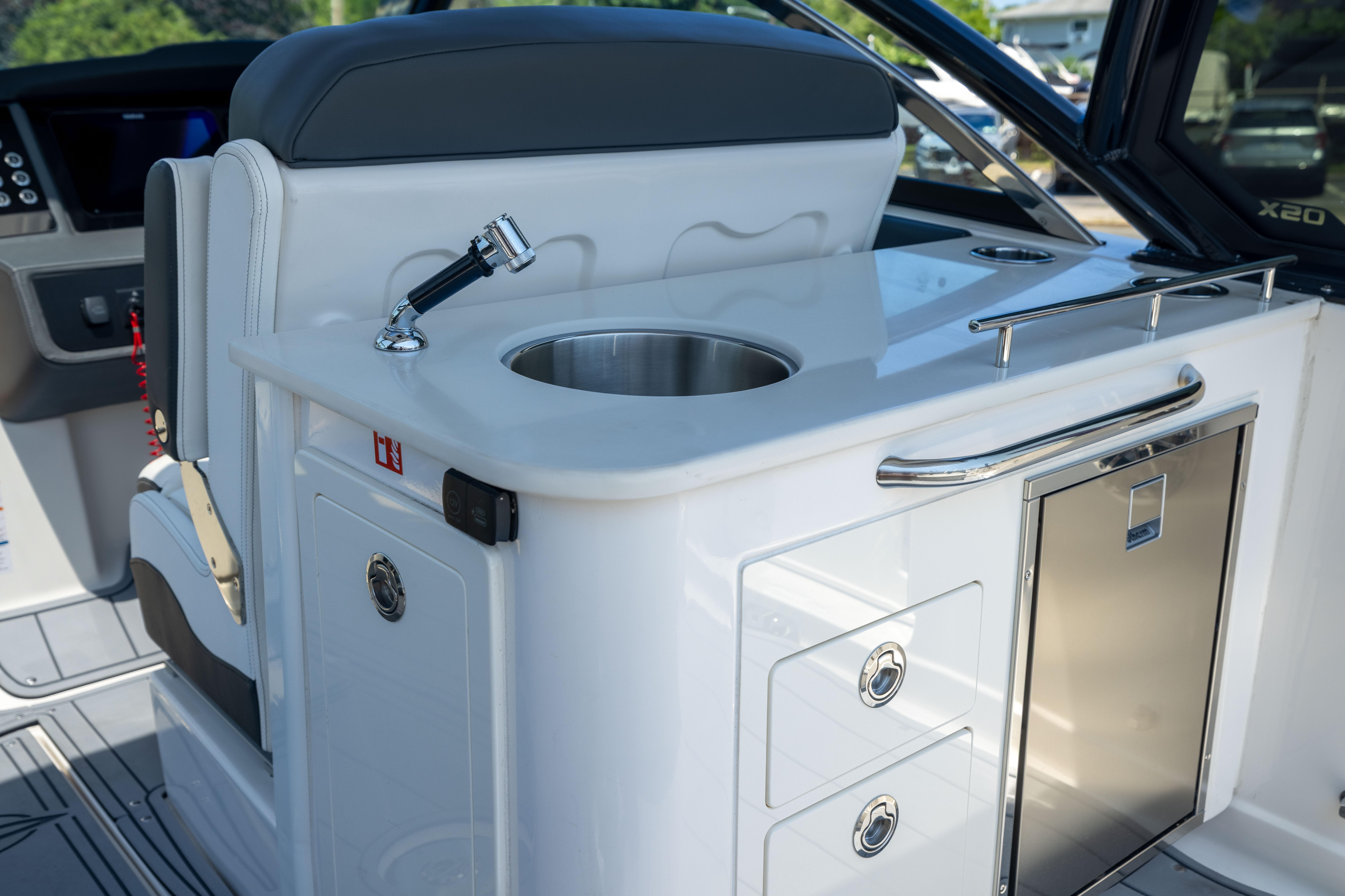 2026 Chaparral 310 OSX boat interior with sink and storage drawers.